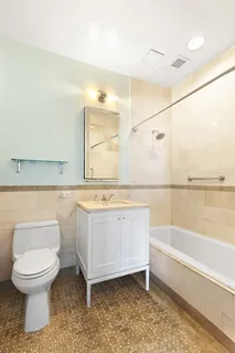 a bathroom with a granite countertop toilet a sink and bathtub