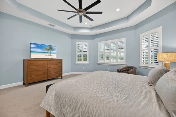 a bedroom with a bed a dresser and a window