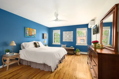 a bedroom with a bed and windows