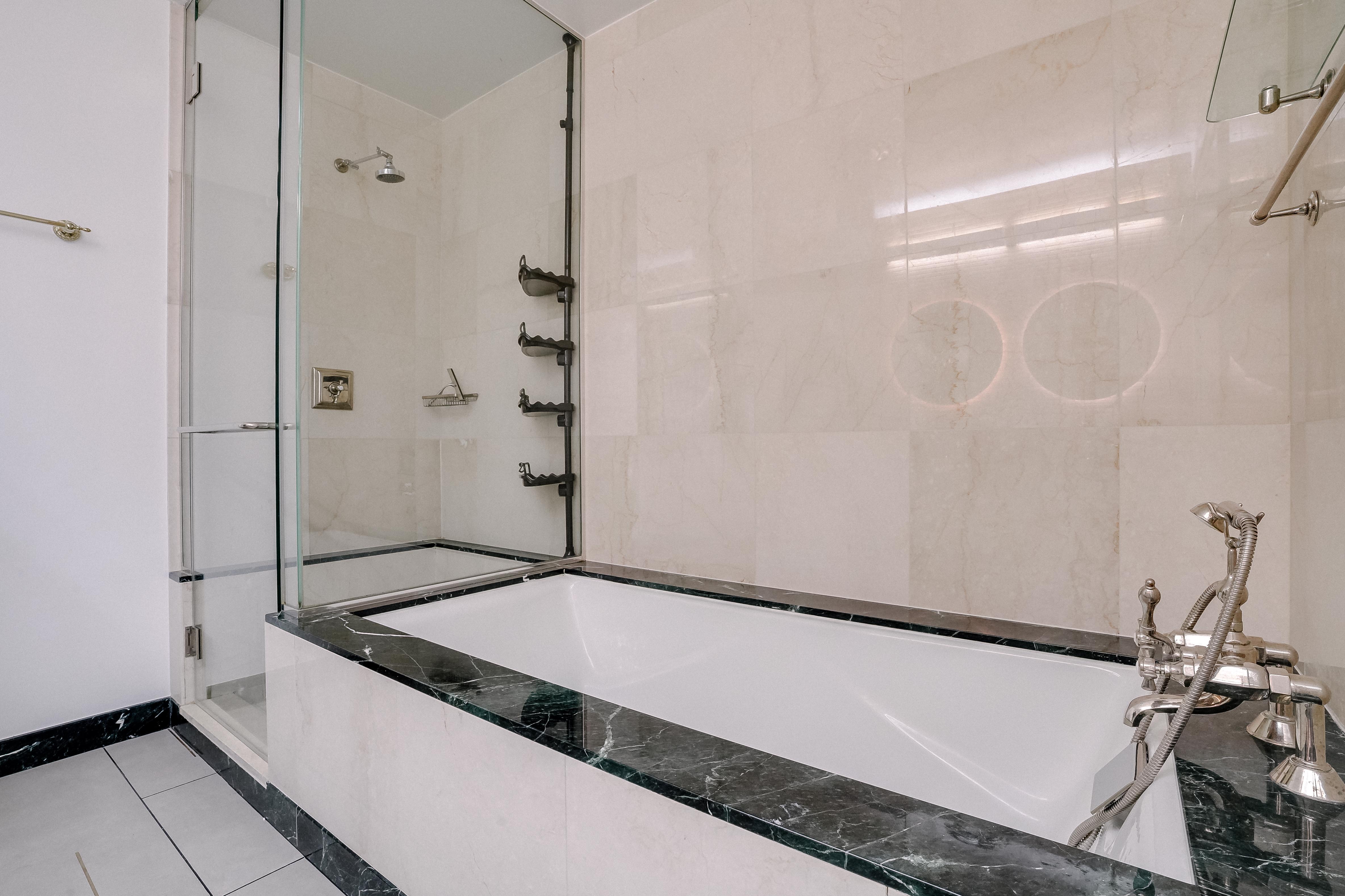 55 Wall Street, Unit PH910 Manhattan, NY 10005 - Photo 12 of 19 a bathroom with a granite countertop sink a mirror and a shower