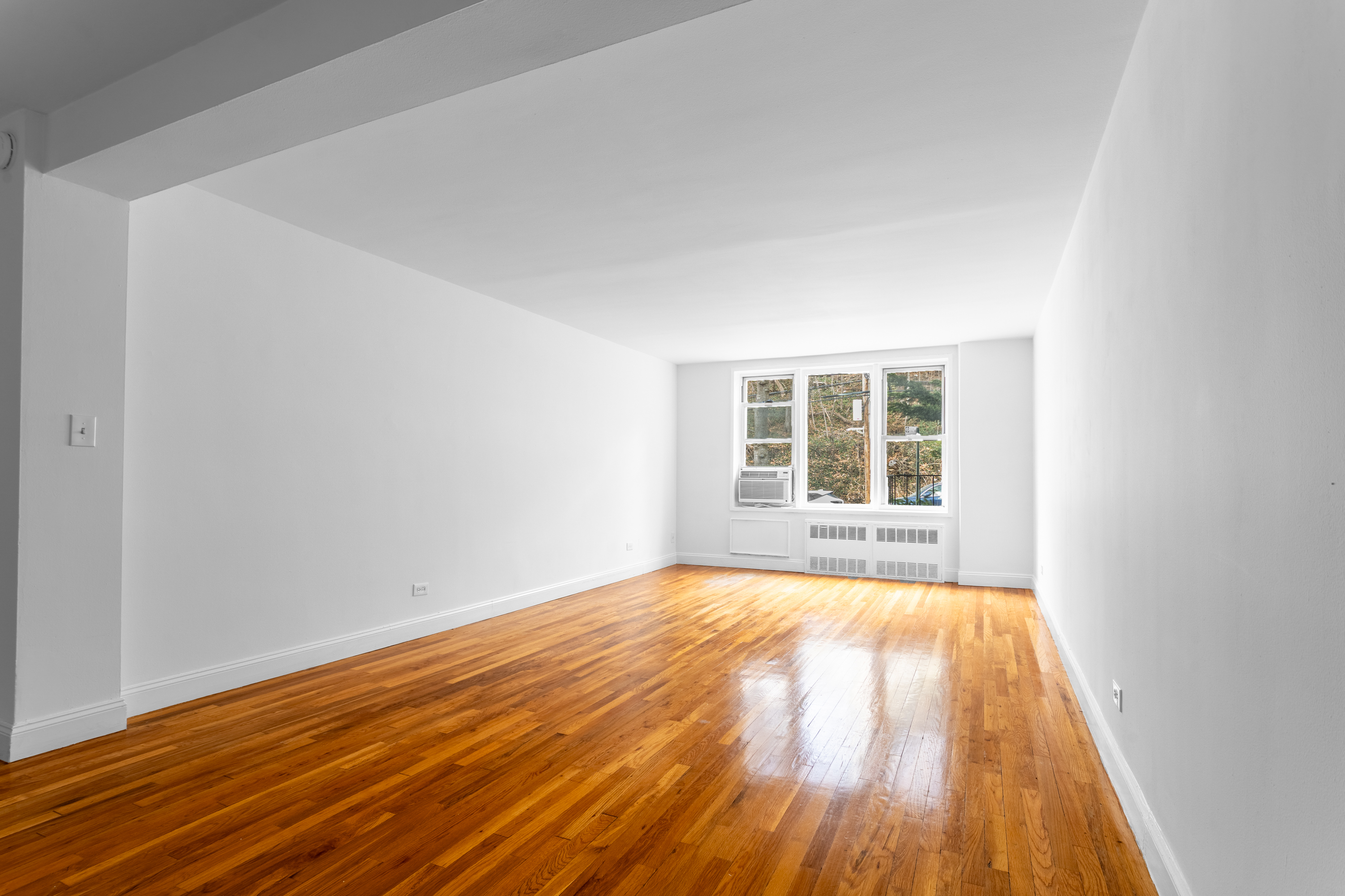 2750 Johnson Avenue, Unit 6E Bronx, NY 10463 - Photo 8 of 14 a view of an empty room with wooden floor and a window