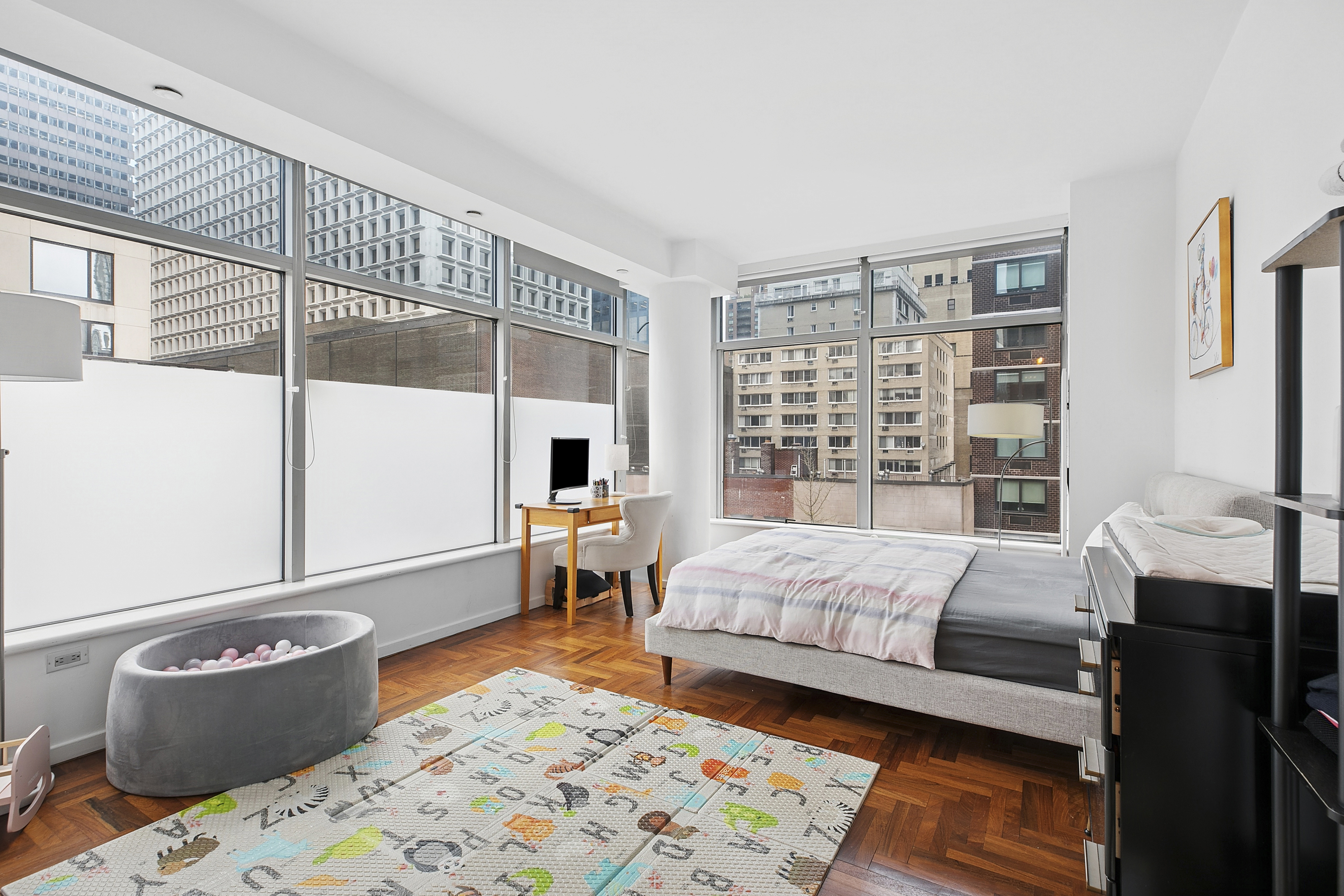 250 East 54th Street, Unit 6A Manhattan, NY 10022 - Photo 4 of 13 a bedroom with a bed and a window