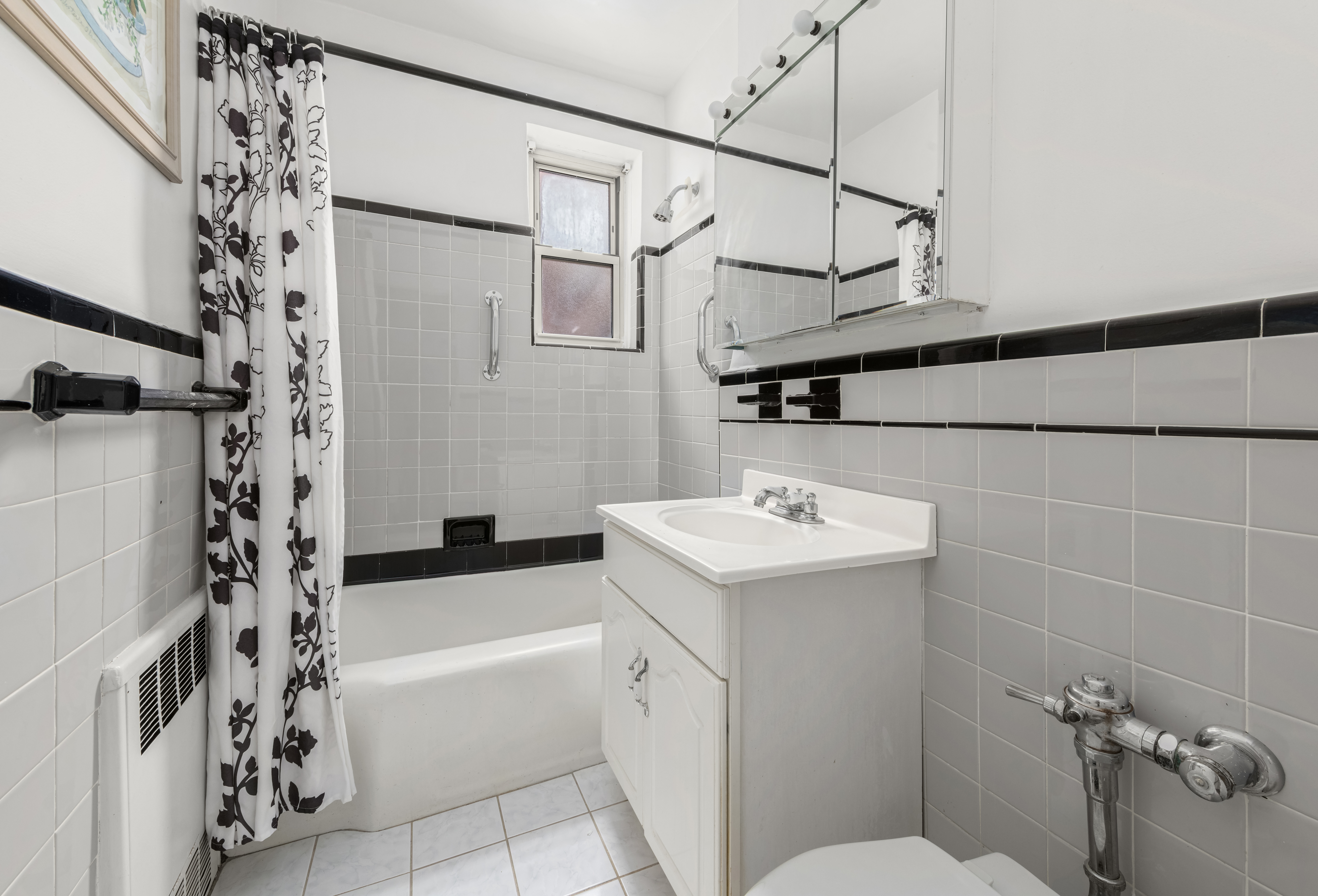 68-61 Yellowstone Boulevard, Unit 618 Queens, NY 11375 - Photo 8 of 13 a bathroom with a sink a toilet and shower