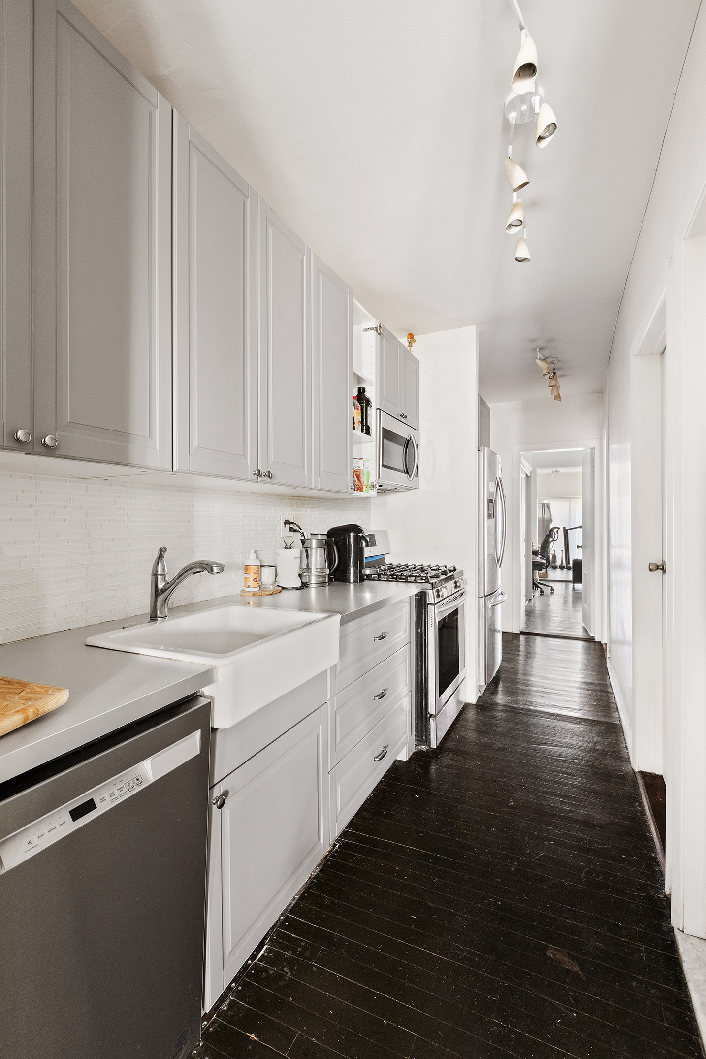 138 West 73rd Street Manhattan, NY 10023 - Photo 31 of 35 a kitchen with granite countertop white cabinets and white appliances