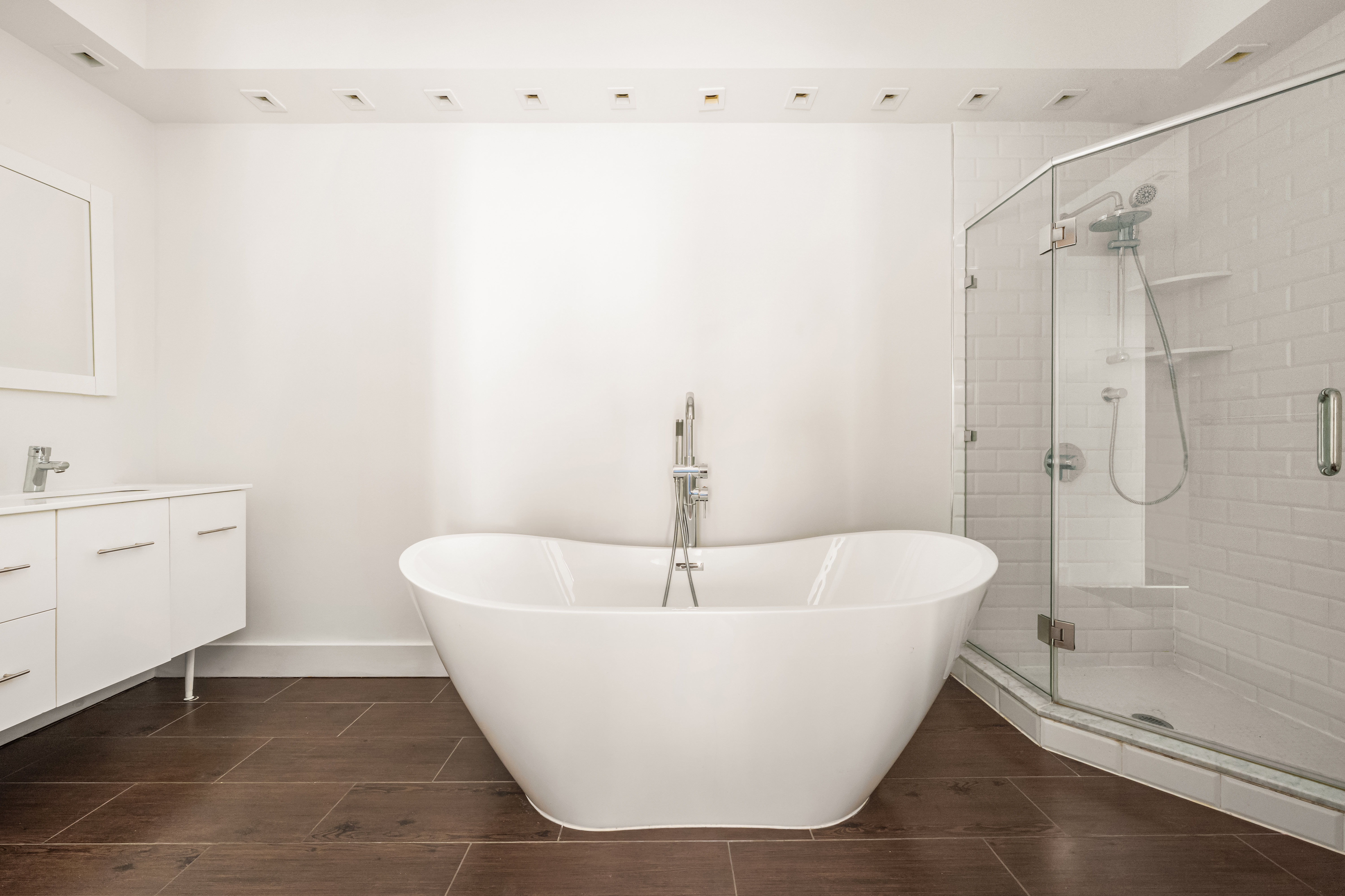 519 Broadway, Unit PHC Manhattan, NY 10012 - Photo 7 of 16 a white bath tub sitting in a bathroom