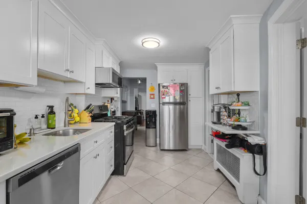 a kitchen with refrigerator and cabinets