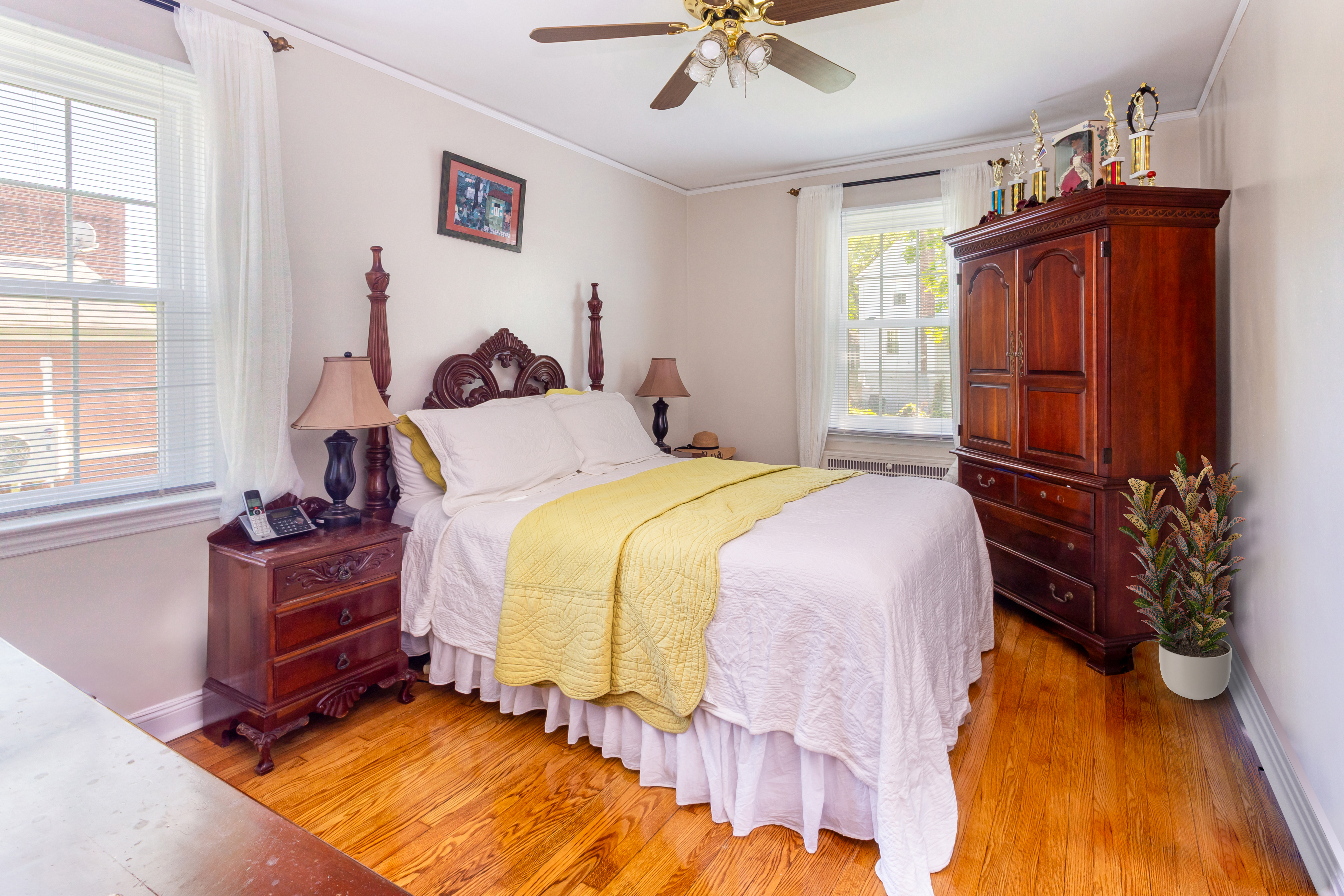 4167 Bruner Avenue Bronx, NY 10466 - Photo 4 of 16 a bedroom with a bed and a chandelier