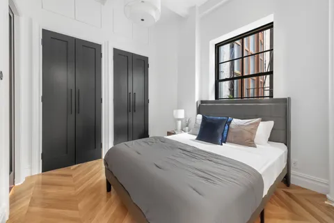 a bedroom with a bed and a window