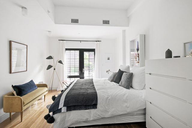 42 Maspeth Avenue, Unit 1D Brooklyn, NY 11211 - Photo 6 of 28 a bedroom with a bed and wooden floor