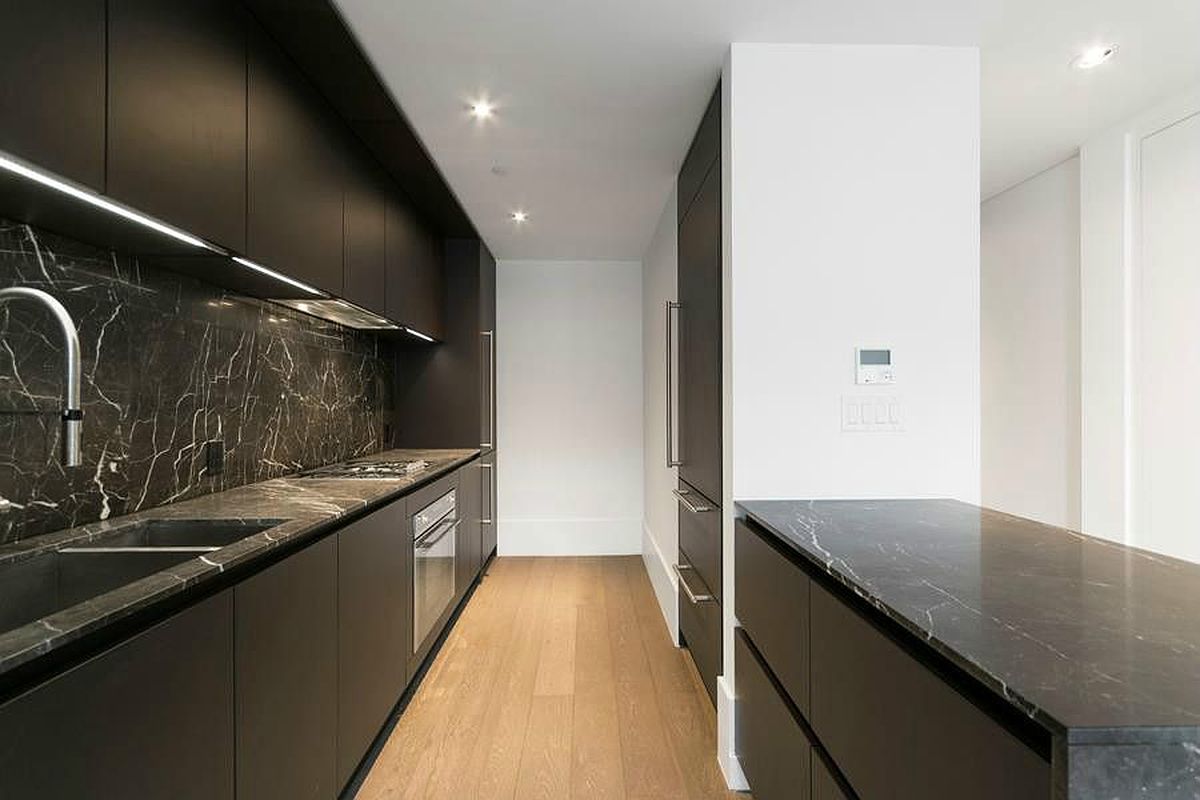 429 Kent Avenue, Unit 607 Brooklyn, NY 11249 - Photo 2 of 14 a large kitchen with granite countertop a sink and a stove