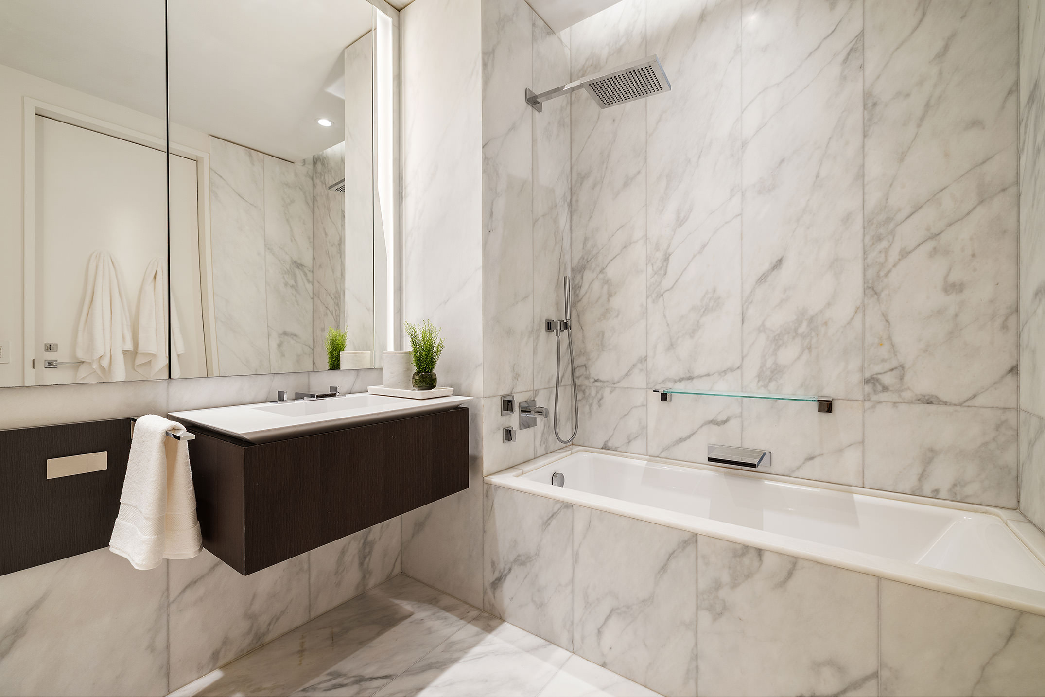 520 West 28th Street, Unit 18 Manhattan, NY 10001 - Photo 16 of 21 a bathroom with a tub sink and mirror