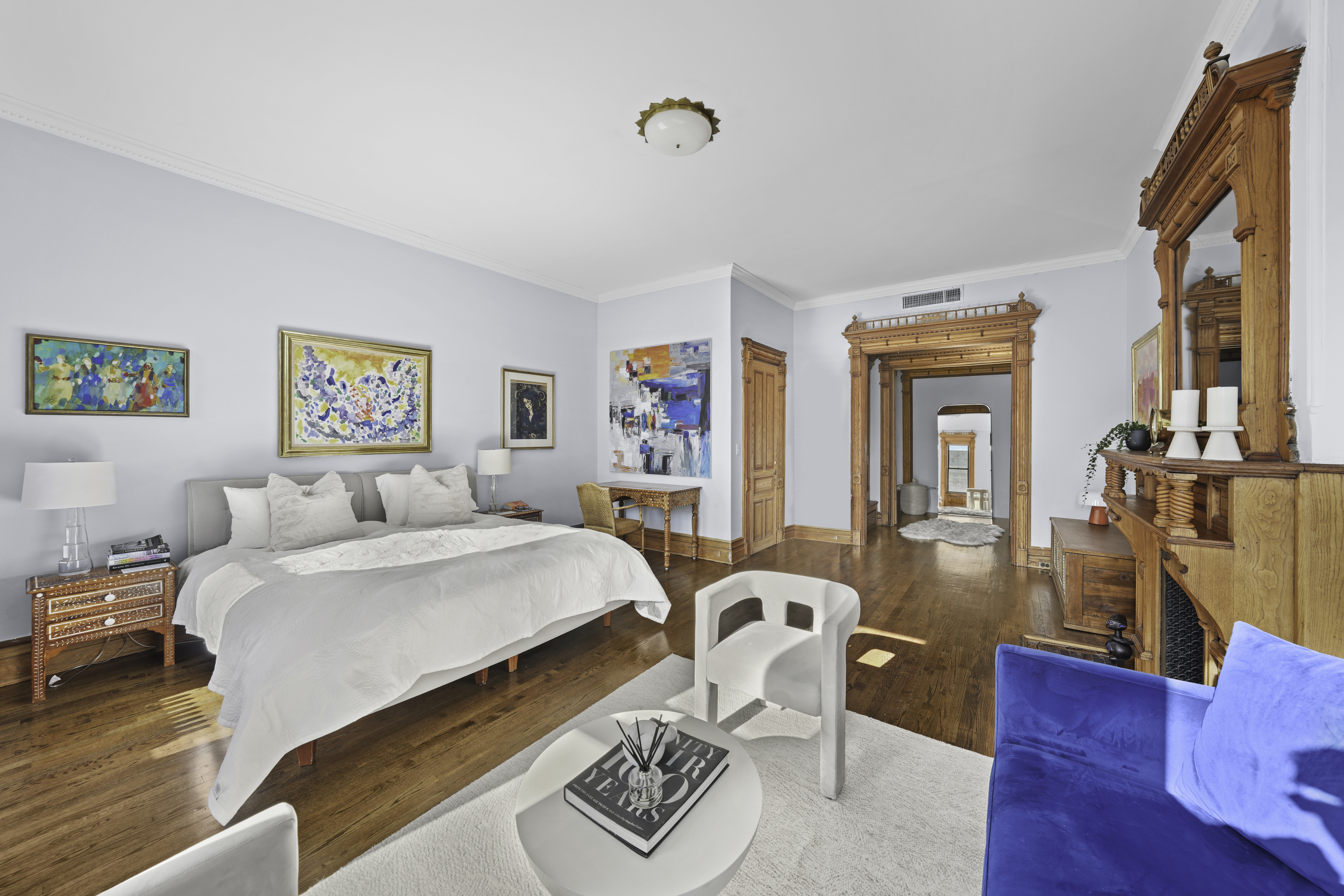 127 West 122nd Street Manhattan, NY 10027 - Photo 12 of 17 a bedroom with a bed and wooden floor
