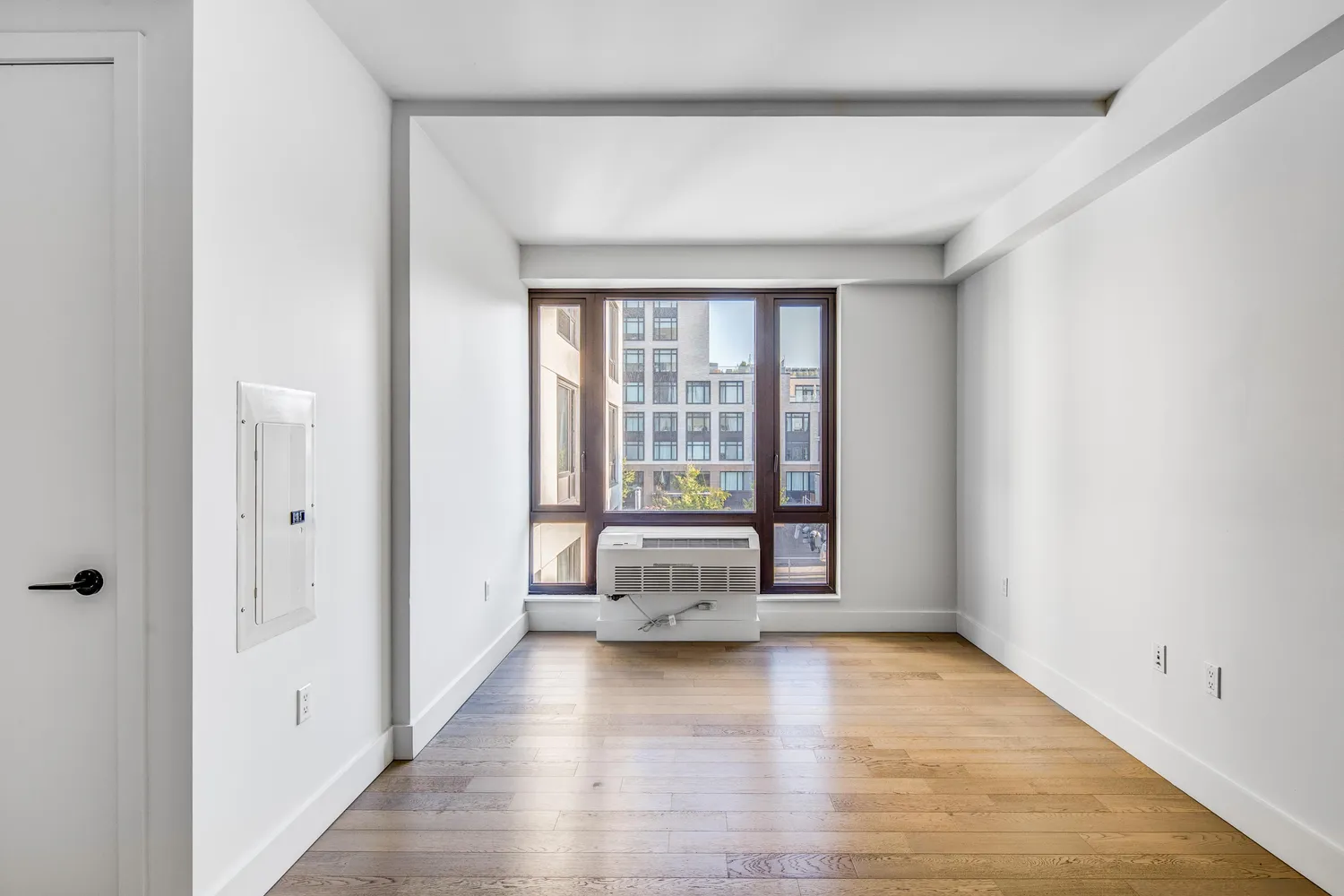 wooden floor in an empty room with a window