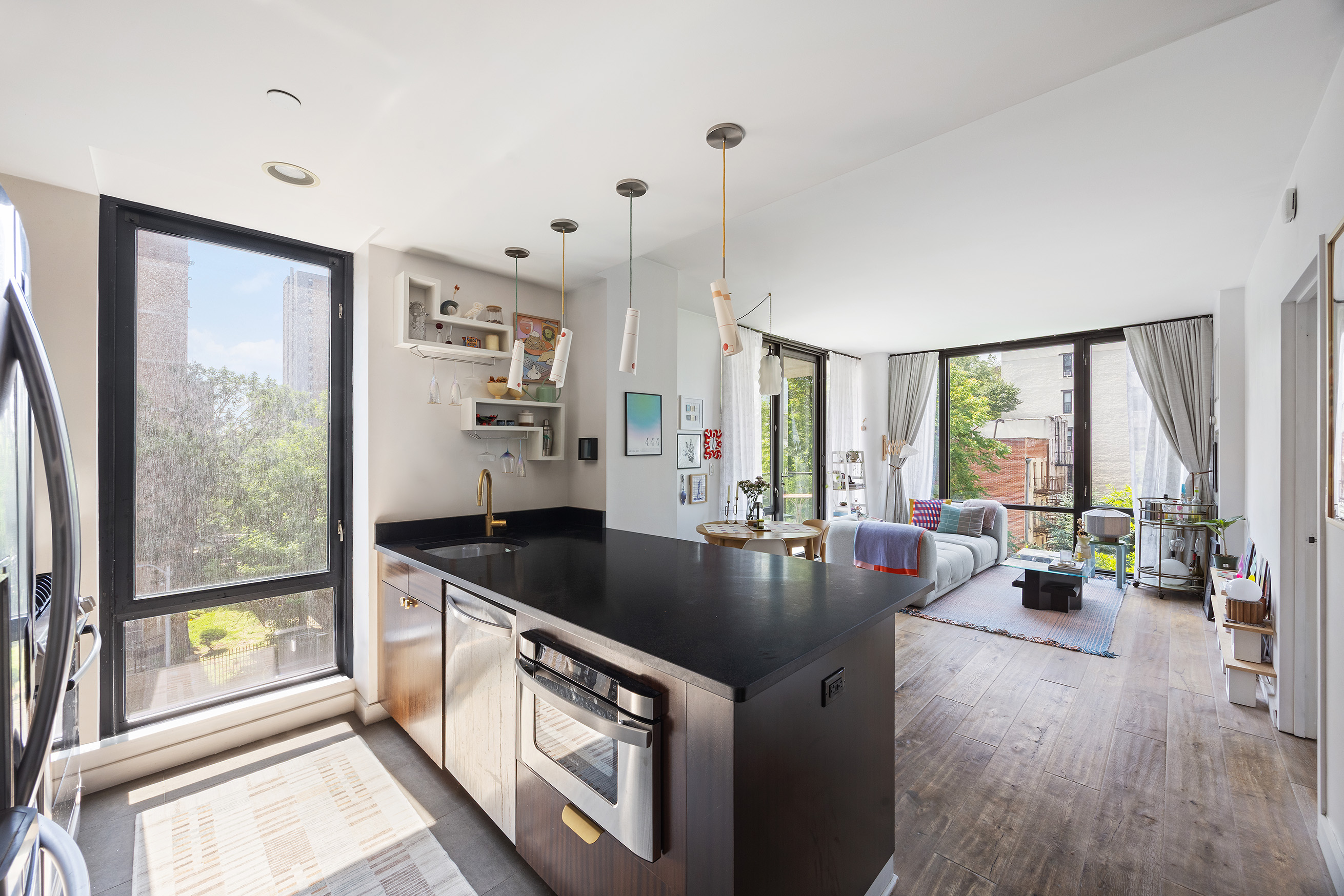 215 Avenue B, Unit 4A Manhattan, NY 10009 - Photo 3 of 13 a kitchen with stainless steel appliances granite countertop a sink a stove and a refrigerator