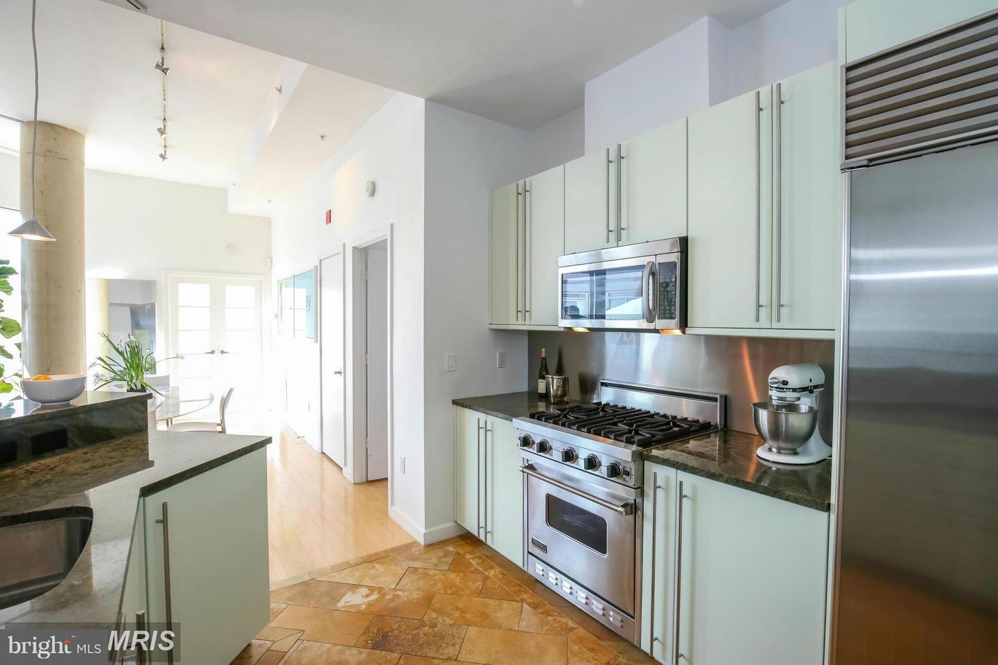 1300 13th Street Northwest, Unit 905 Washington, DC 20005 - Photo 5 of 18 a kitchen with stainless steel appliances a stove a refrigerator and a sink