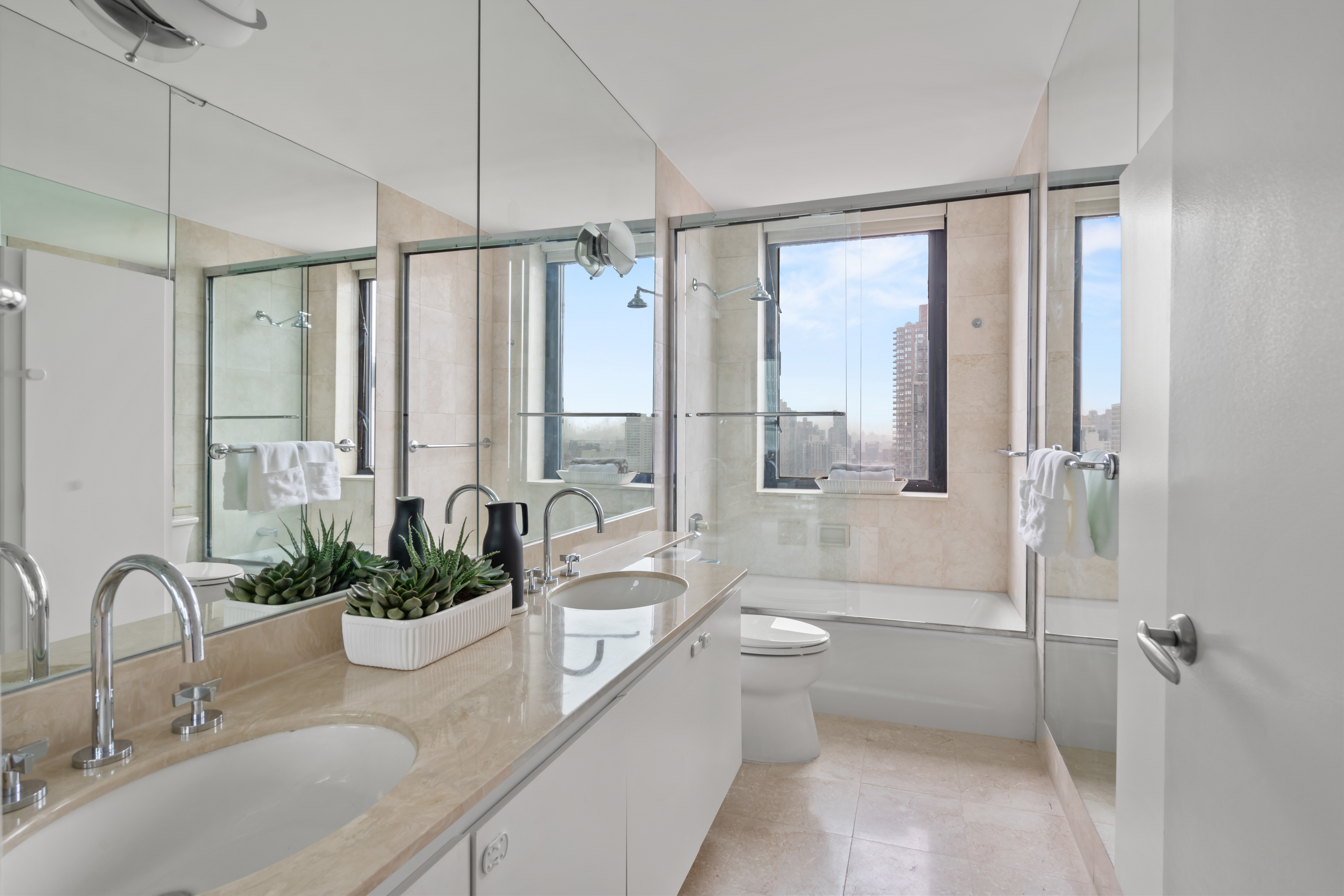 330 East 75th Street, Unit 32A Manhattan, NY 10021 - Photo 9 of 17 a bathroom with a granite countertop sink a toilet and shower