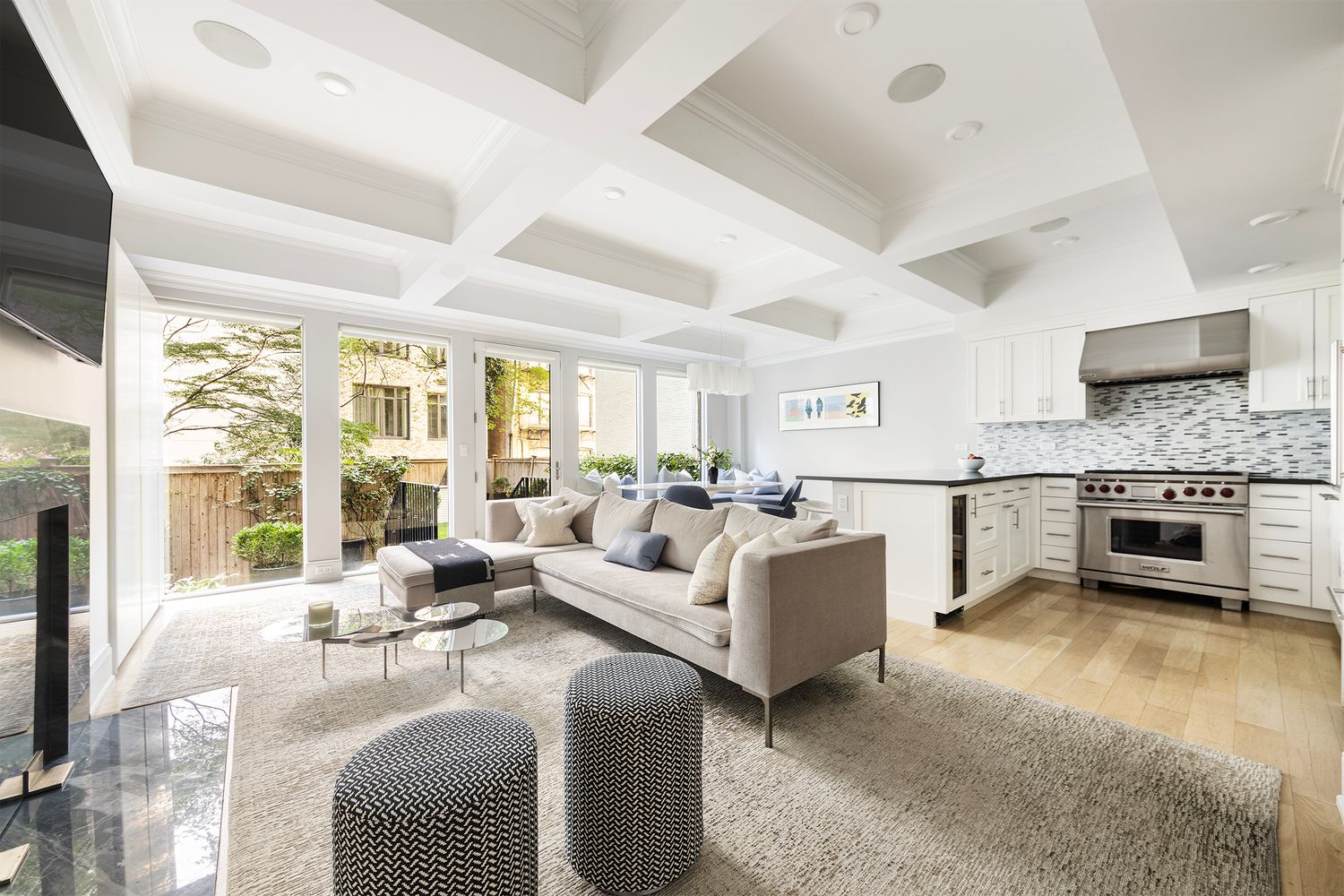 a living room with furniture white walls and a flat screen tv