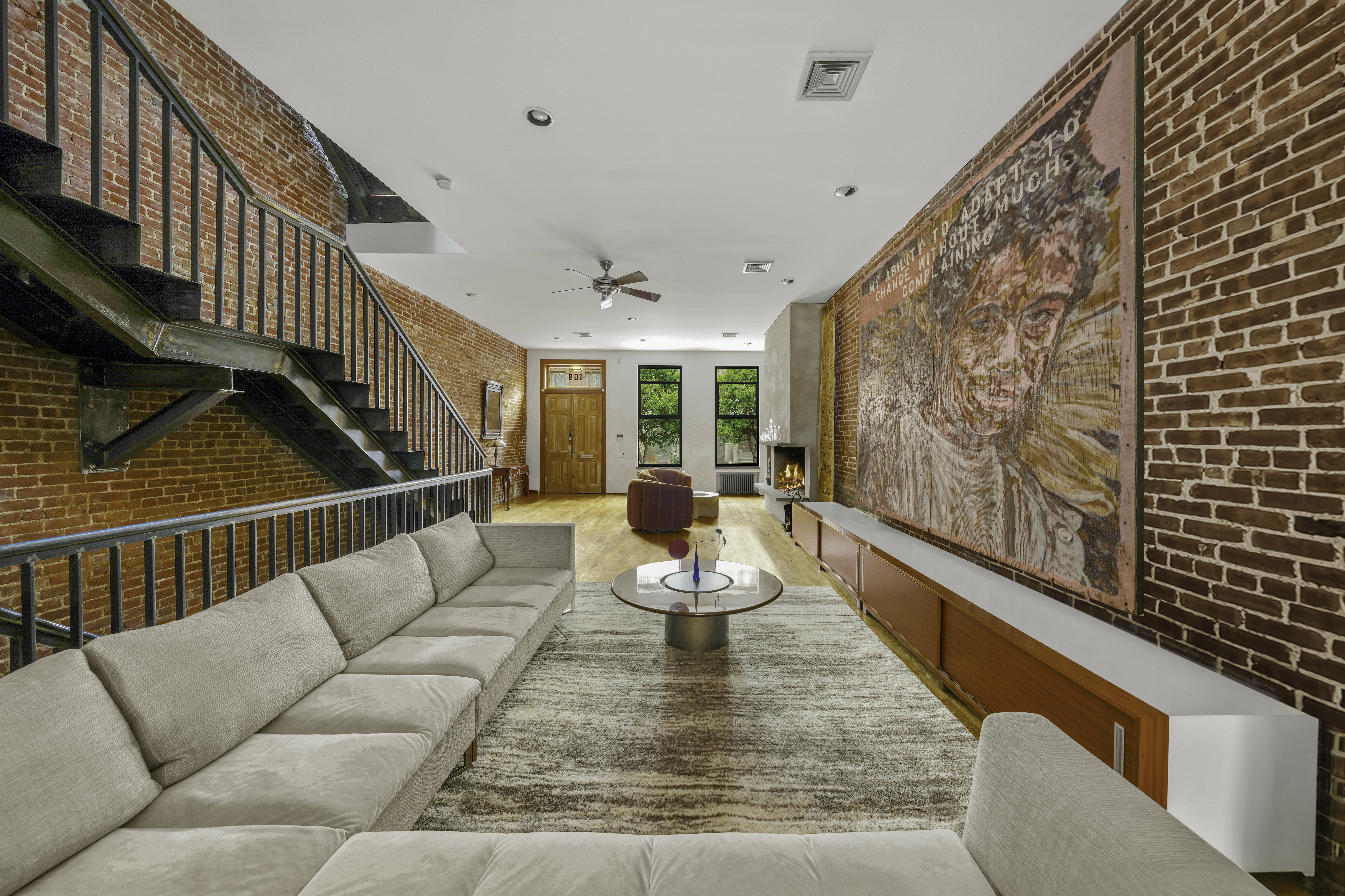 109 West 118th Street Manhattan, NY 10026 - Photo 3 of 31 a living room with furniture and wooden floor