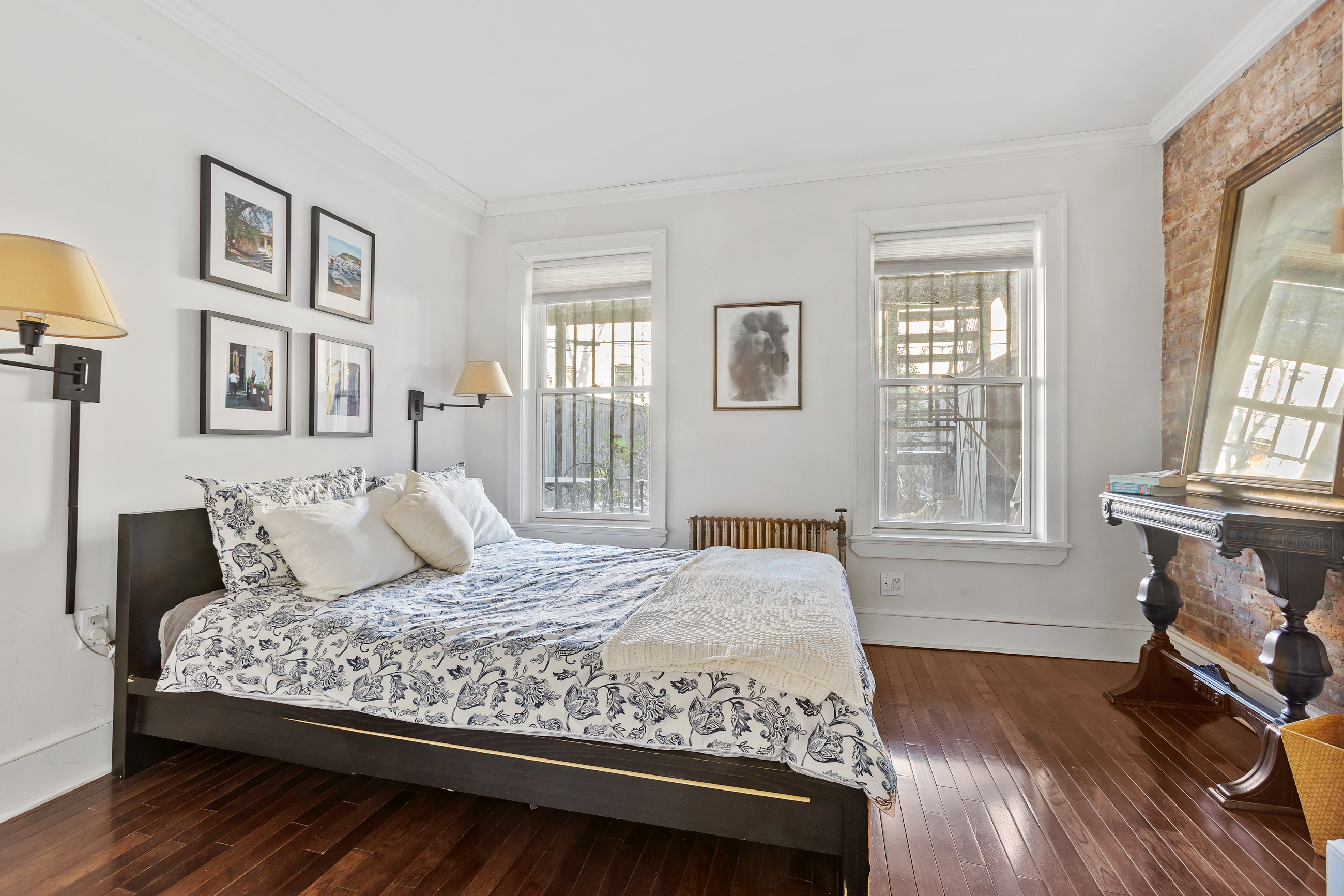 a bedroom with a large bed and a fireplace