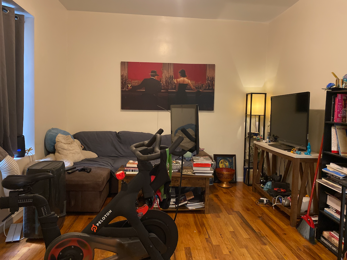 470 West 166th Street, Unit 21 Manhattan, NY 10032 - Photo 7 of 8 a living room with furniture a flat screen tv and gym equipment