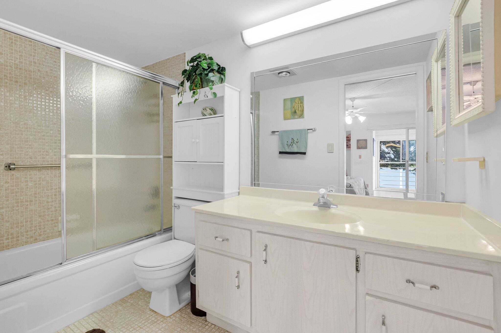 2035 Ainslie C Boca Raton, FL 33434 - Photo 7 of 17 a bathroom with a sink a toilet and shower