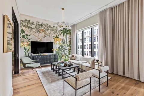 a living room with furniture a flat screen tv and a large window