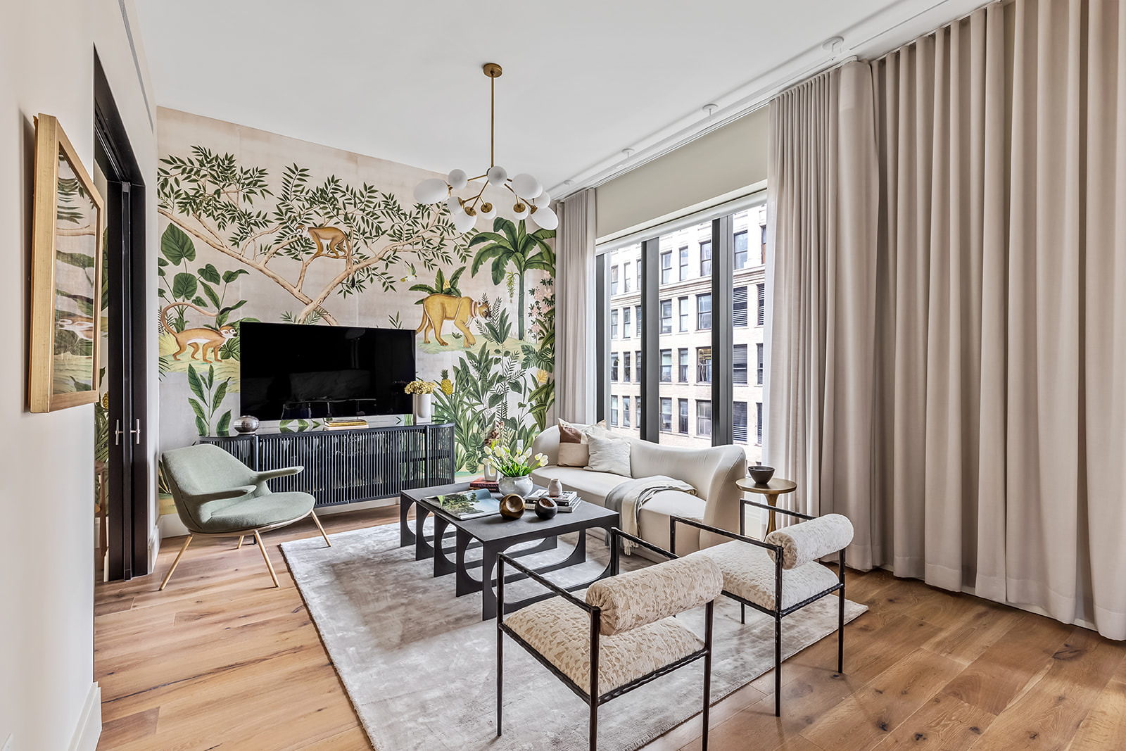 30 East 29th Street, Unit 16A Manhattan, NY 10016 - Photo 2 of 16 a living room with furniture a flat screen tv and a large window