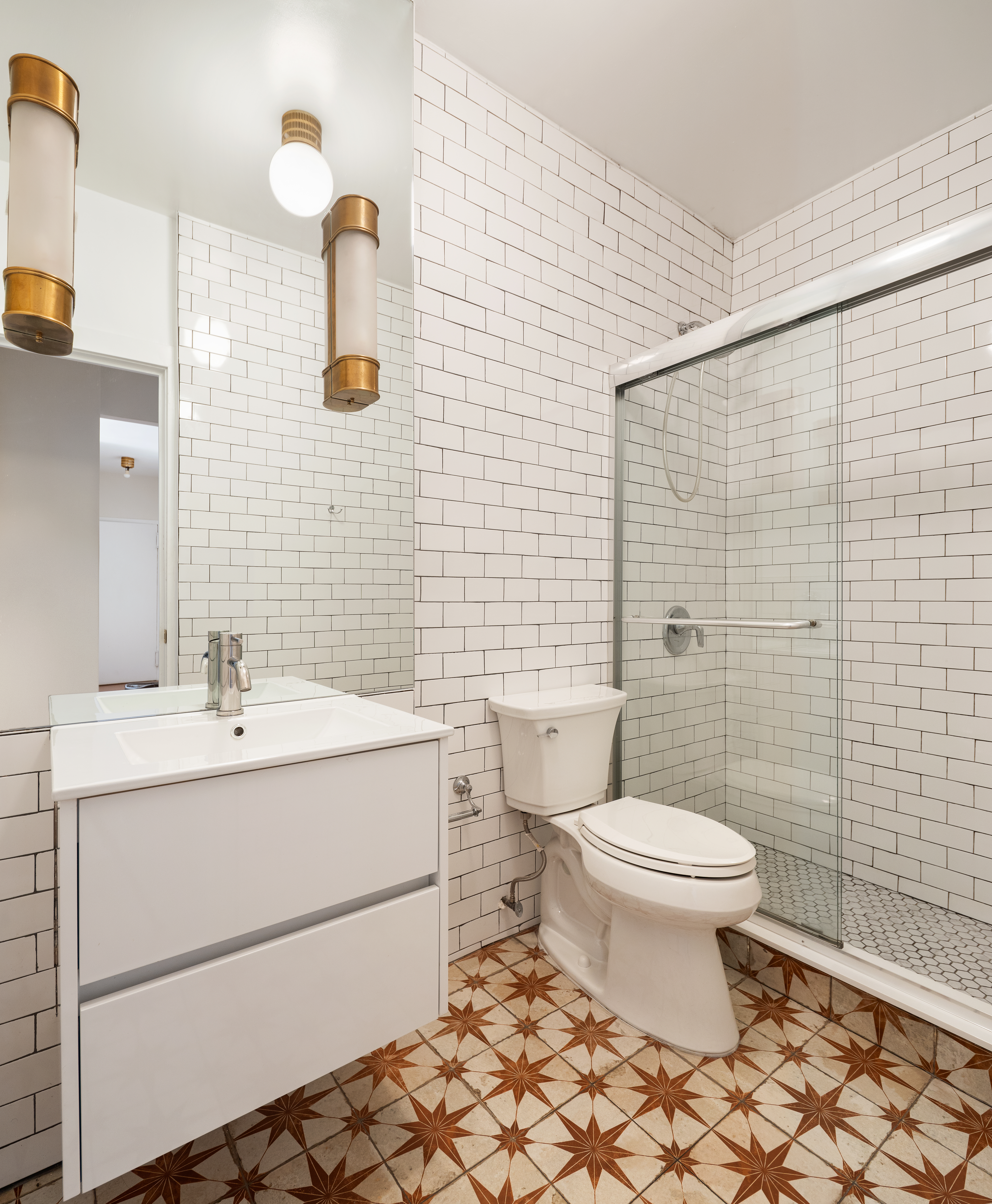 60 East 8th Street, Unit 20P Manhattan, NY 10003 - Photo 6 of 11 a bathroom with a sink toilet and shower