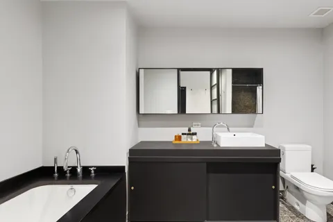 a bathroom with a double vanity sink and a mirror