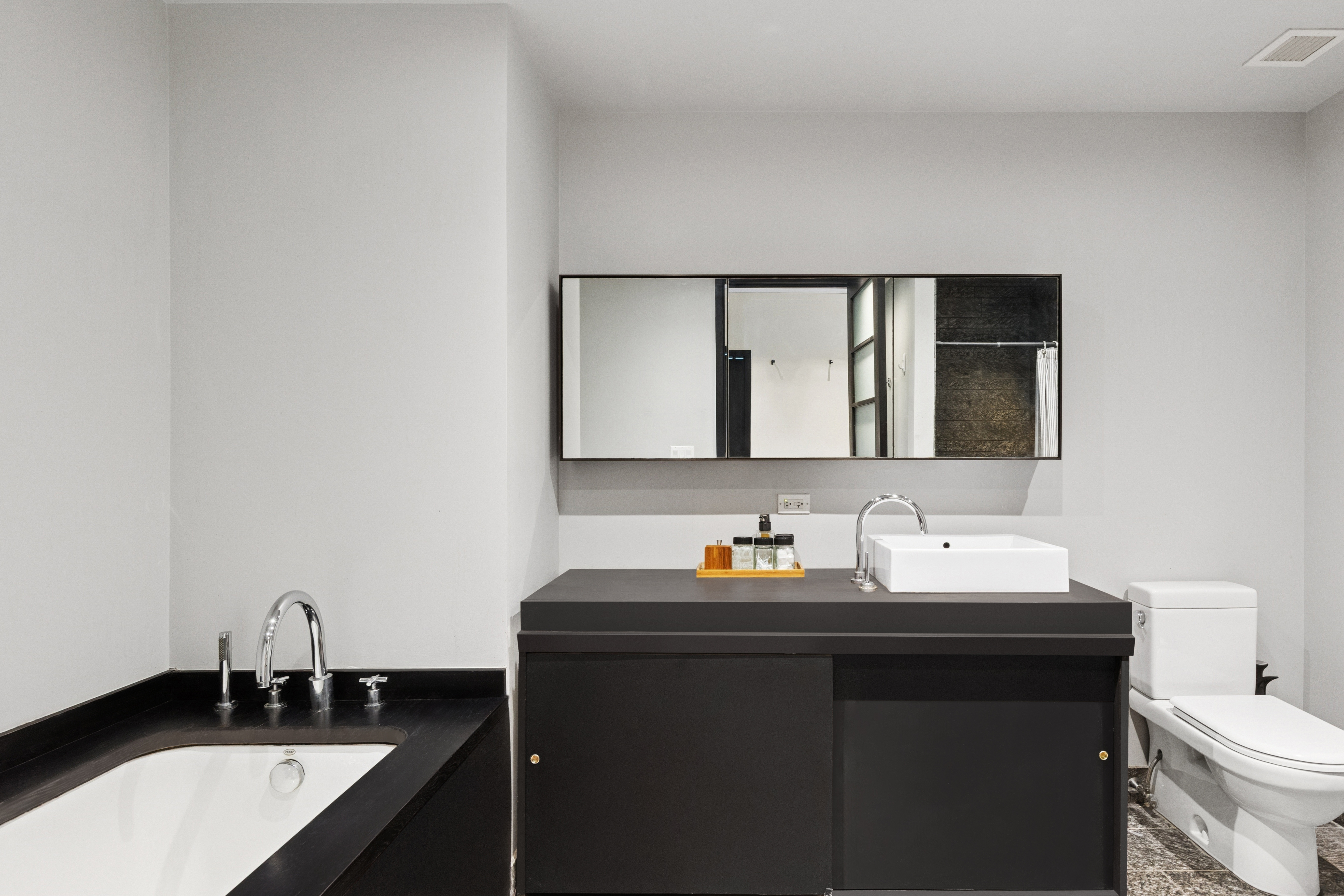 20 Pine Street, Unit 2401 Manhattan, NY 10005 - Photo 4 of 11 a bathroom with a double vanity sink and a mirror