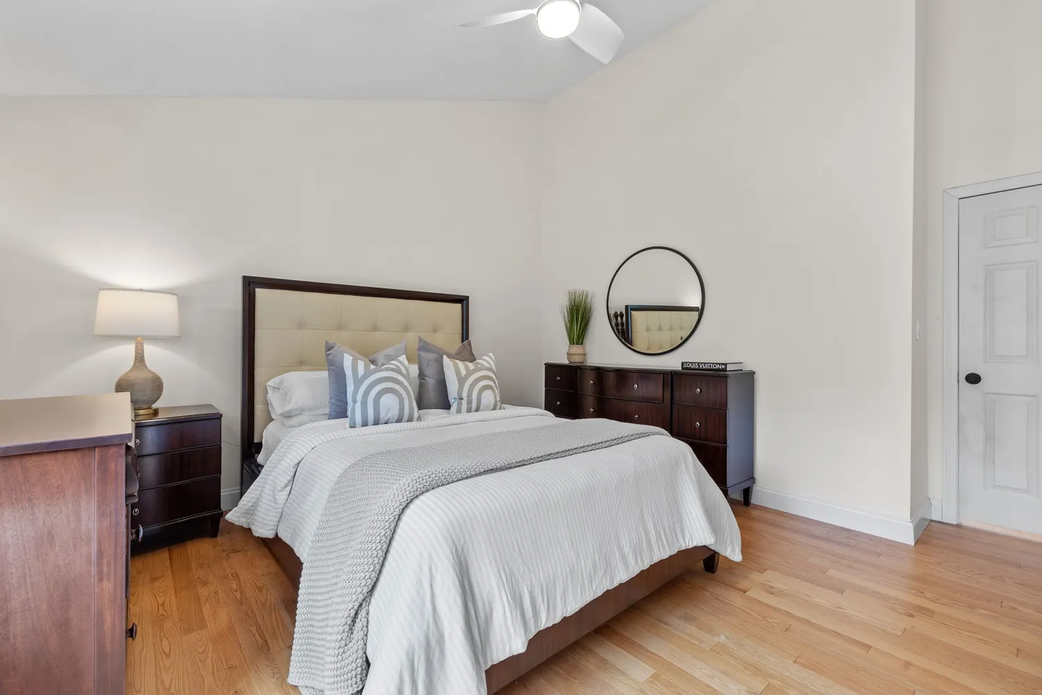 a bed sitting in a bedroom with a lamp
