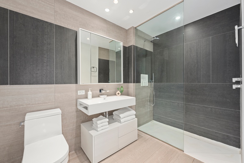 540 West 49th Street, Unit 609N Manhattan, NY 10019 - Photo 3 of 10 a bathroom with a sink toilet and shower