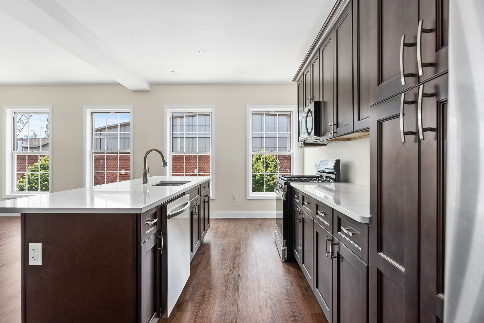 217 Butler Street, Unit 2 Brooklyn, NY 11217 - Photo 4 of 15 a kitchen with stainless steel appliances granite countertop a sink stove and refrigerator