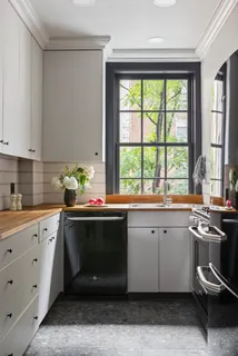a kitchen with a sink cabinets and window