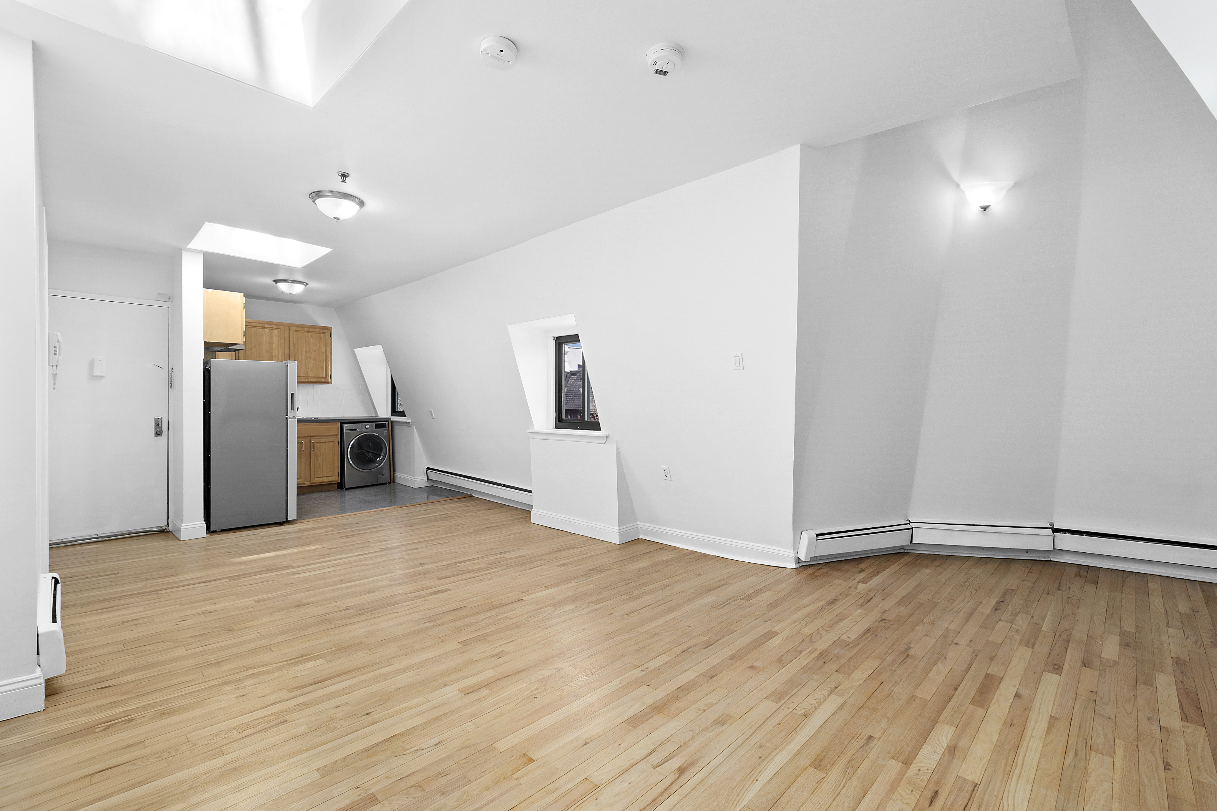 336 Convent Avenue, Unit MLTFMLY Manhattan, NY 10031 - Photo 19 of 20 a view of an empty room with wooden floor