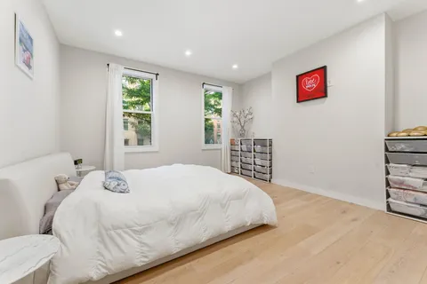 a bedroom with a large bed and a window