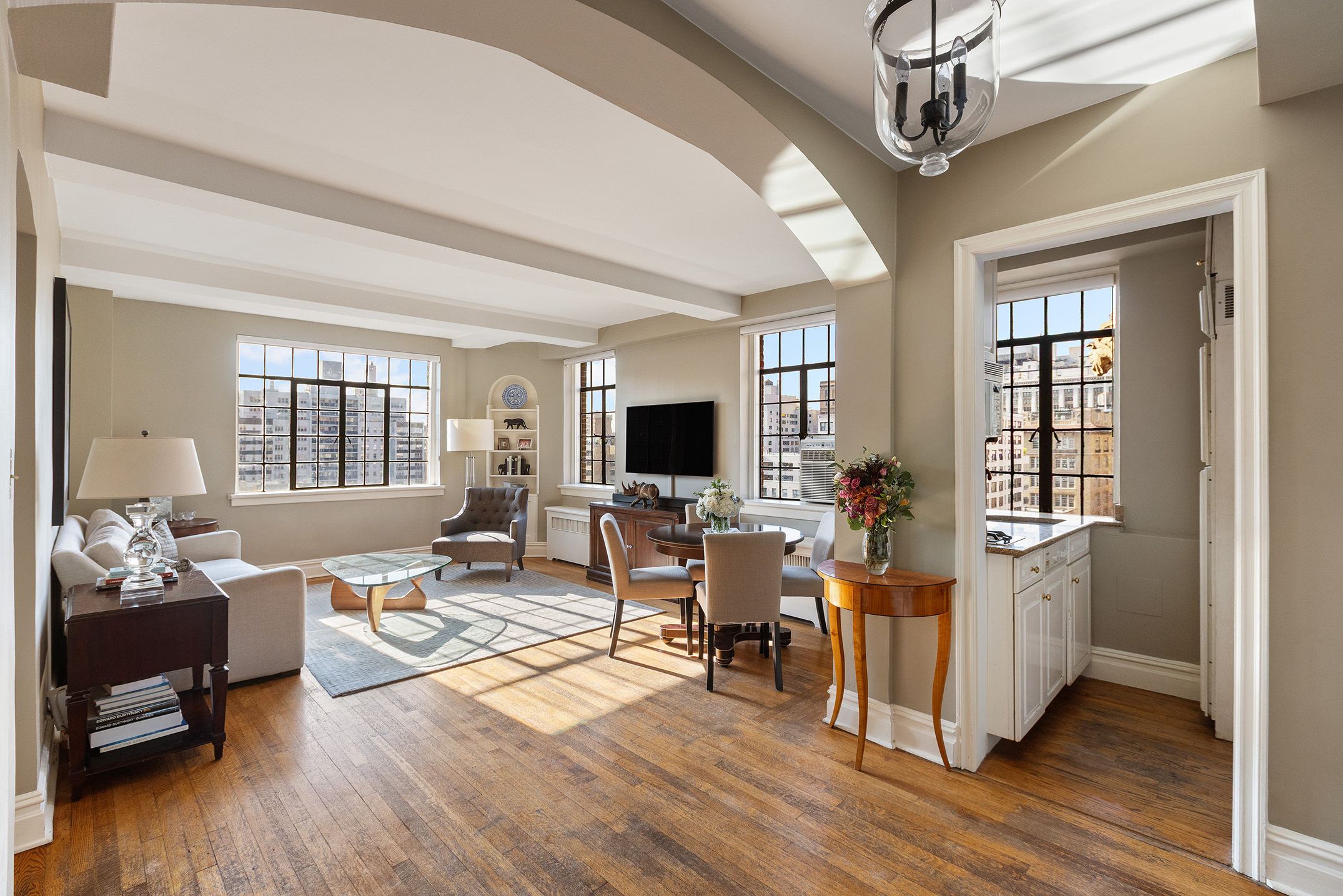 81 Irving Place, Unit 15DE Manhattan, NY 10003 - Photo 4 of 18 a living room with furniture flat screen tv and wooden floor