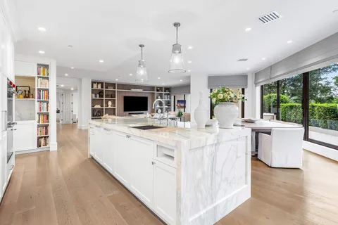 a large kitchen with stainless steel appliances a large center island and a stove