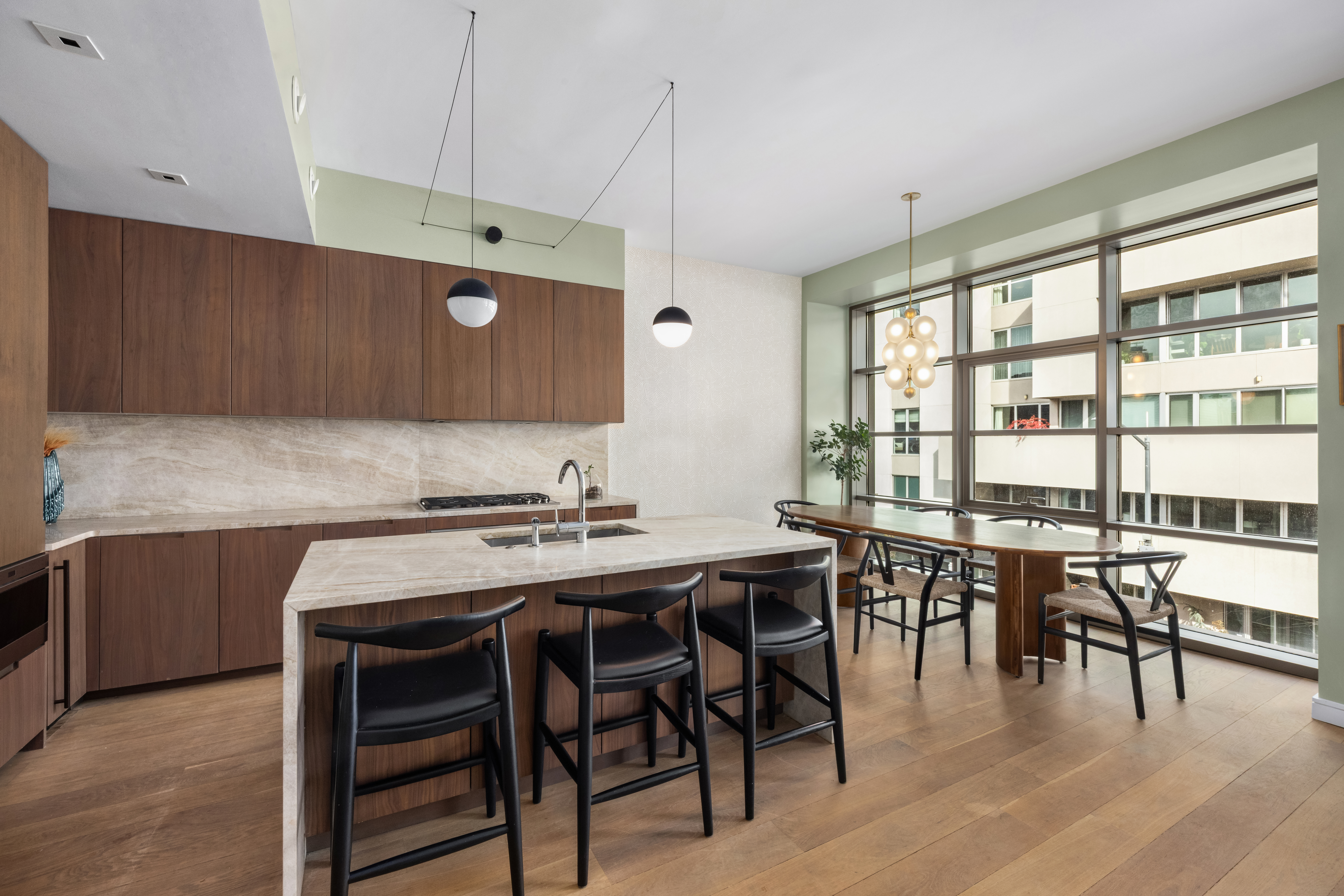 138 North 10th Street, Unit 302 Brooklyn, NY 11249 - Photo 6 of 15 a kitchen with stainless steel appliances granite countertop dining table chairs and wooden floor