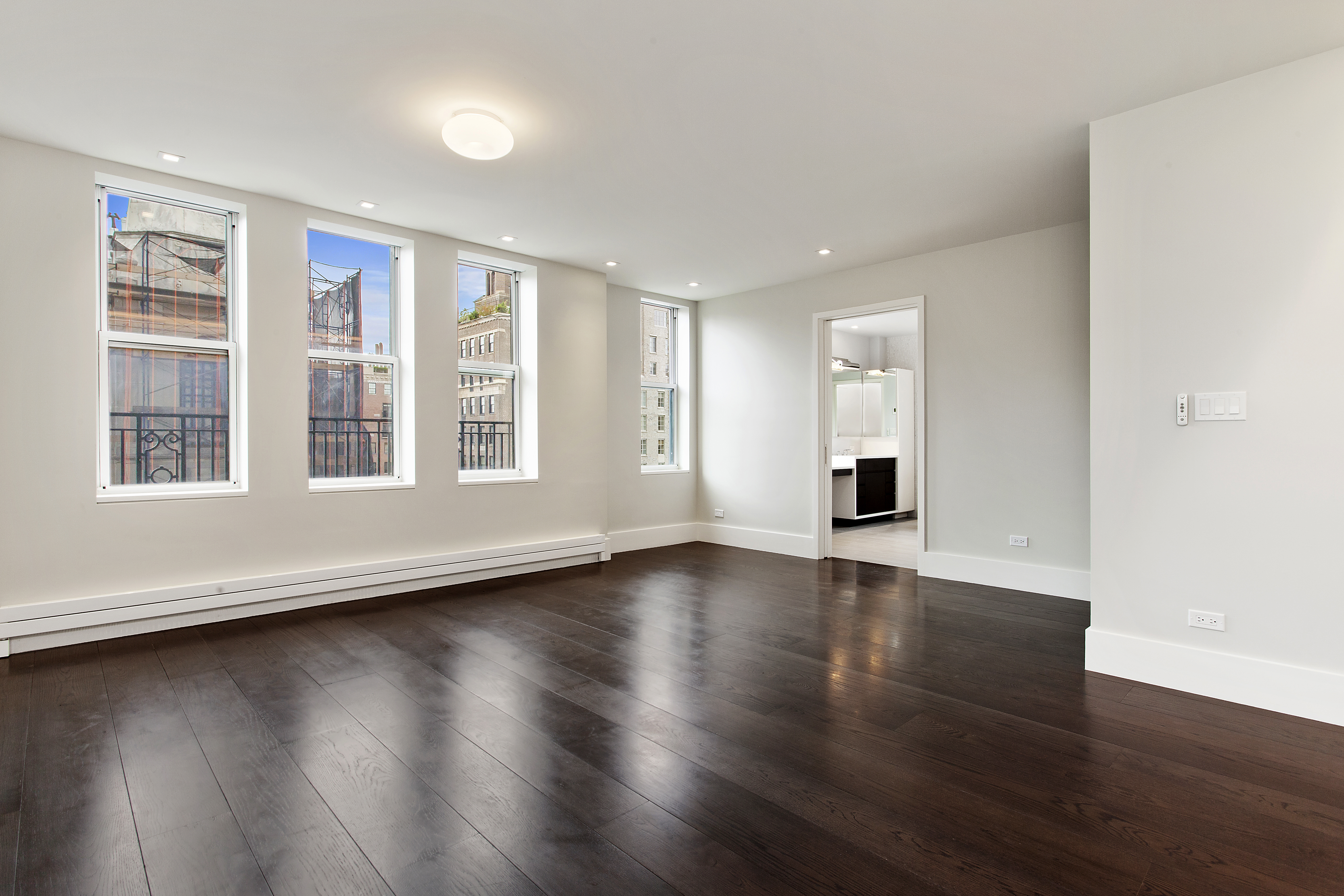 East 80th Street Manhattan, NY 10075 - Photo 8 of 13 a view of an empty room with wooden floor and windows