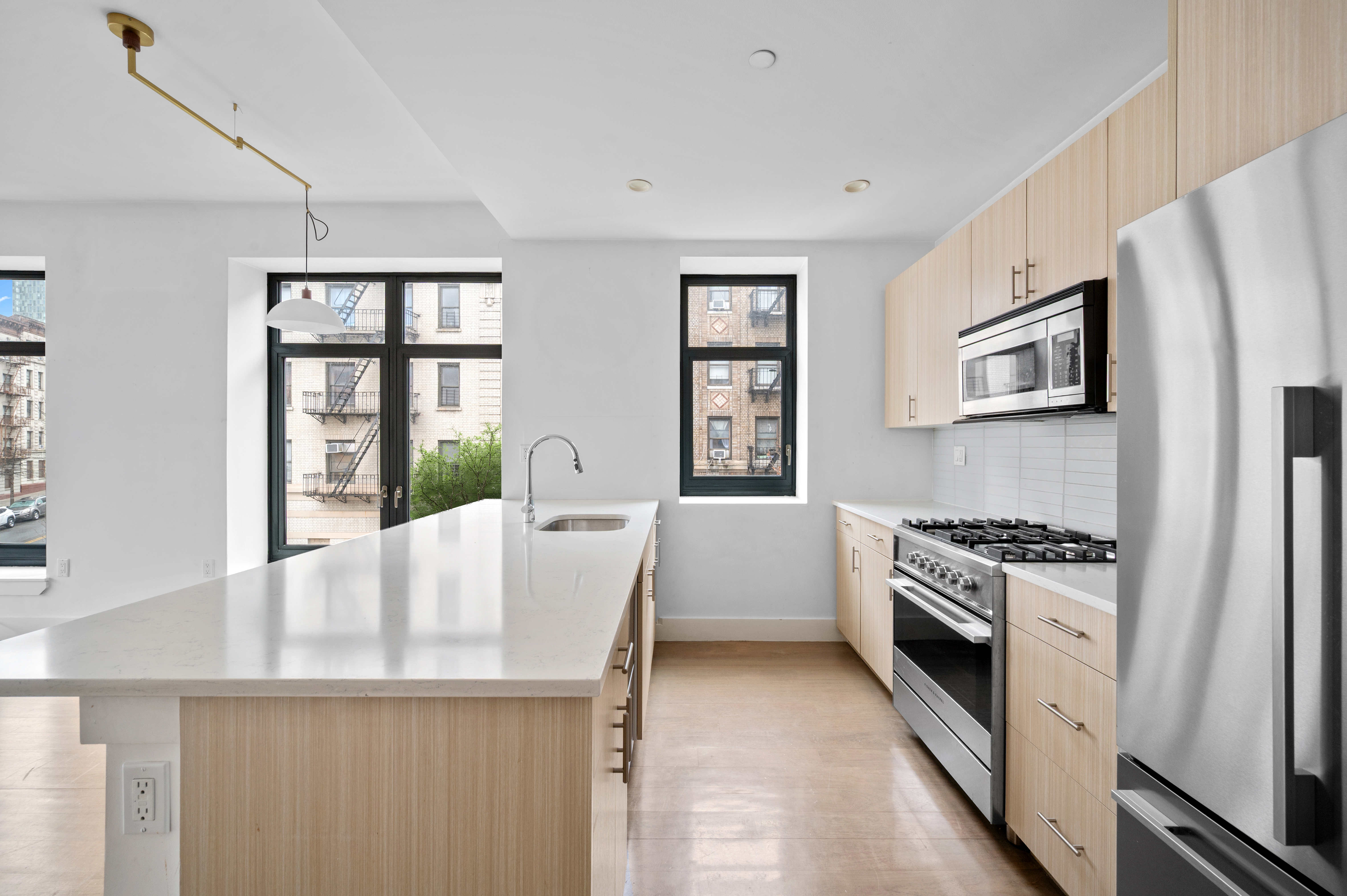 17 Convent Avenue Manhattan, NY 10027 - Photo 4 of 15 a kitchen with stainless steel appliances a white stove top oven and a refrigerator