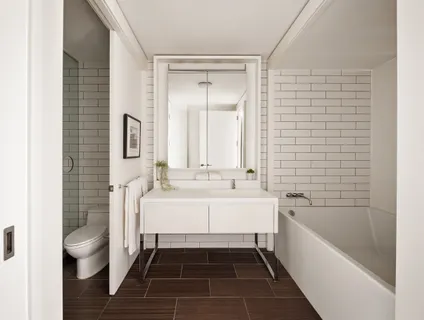 a bathroom with a sink a toilet and bathtub