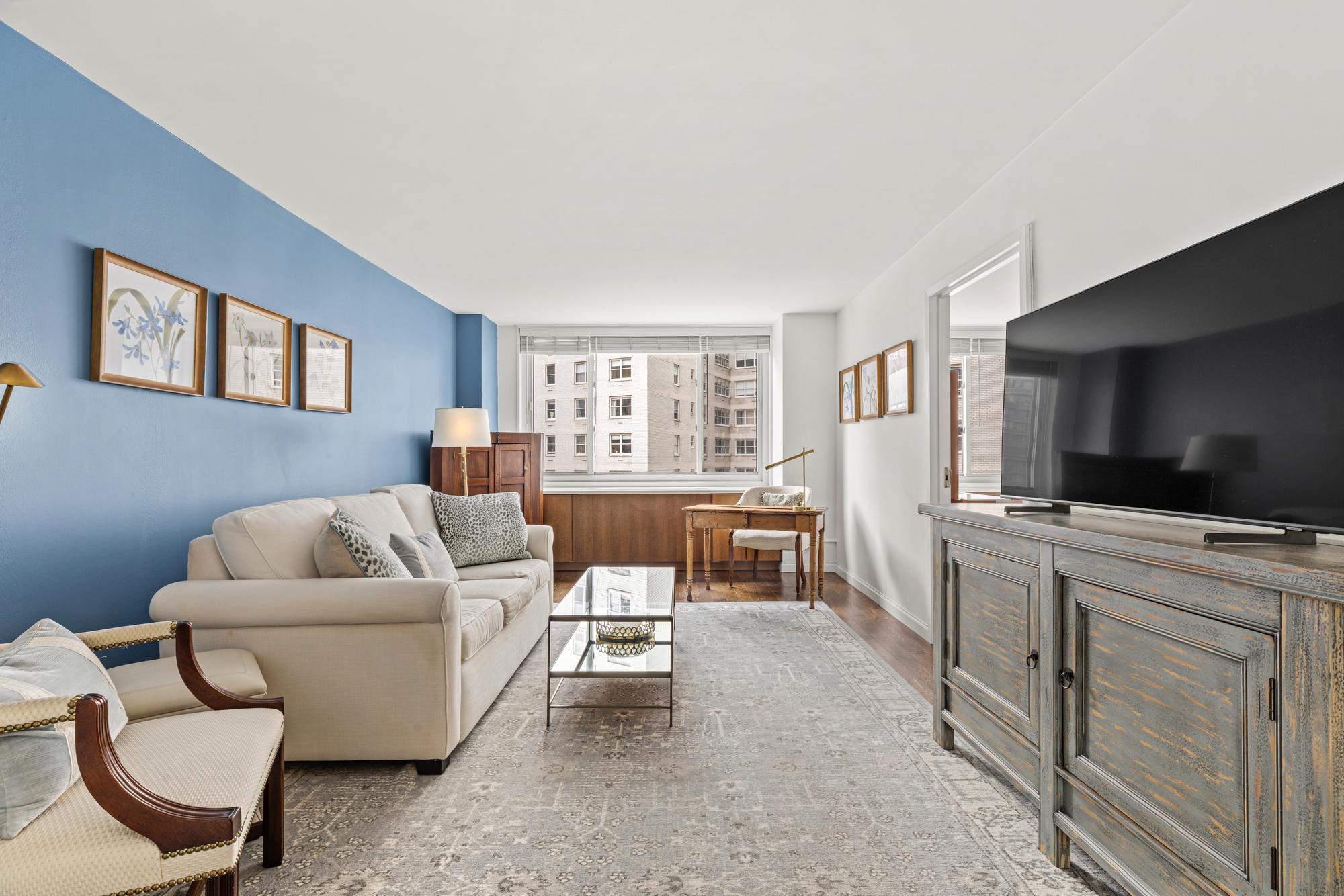 a living room with furniture and a flat screen tv