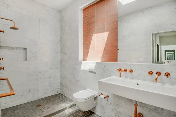 a bathroom with a sink toilet and a mirror