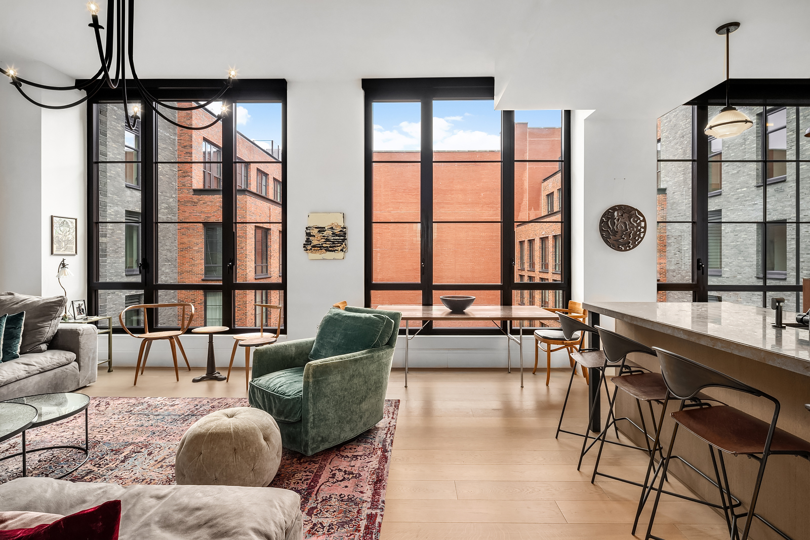 a living room with furniture and floor to ceiling windows