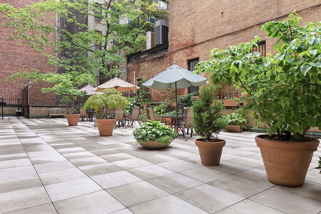 310 Lexington Avenue, Unit 3E Manhattan, NY 10016 - Photo 5 of 6 a view of a patio with potted plants and a fountain