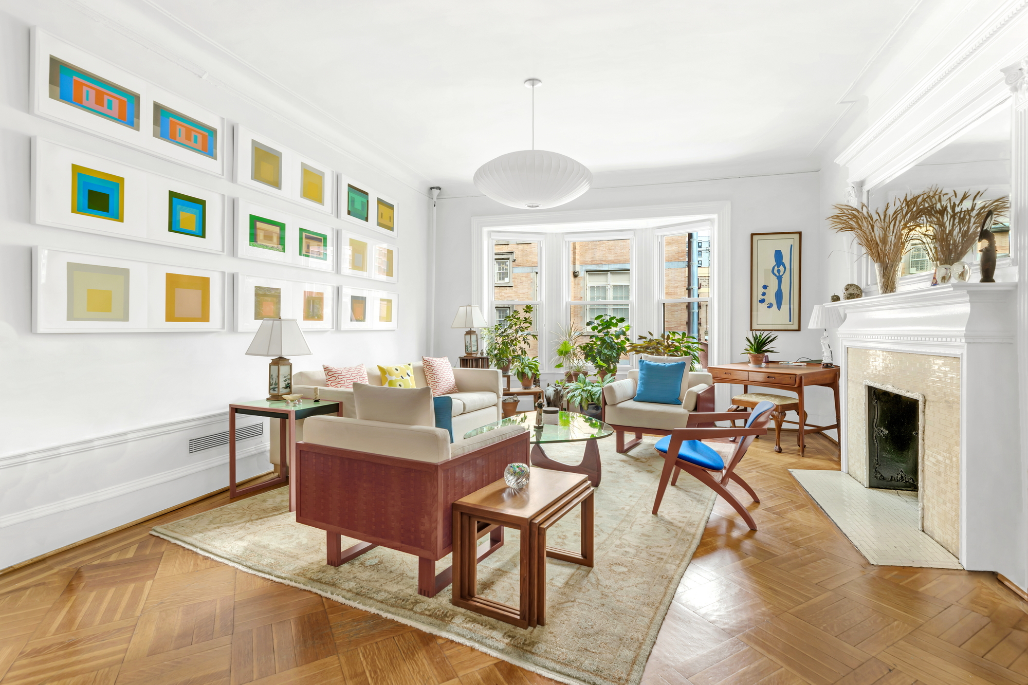 254 West 82nd Street, Unit 5A Manhattan, NY 10024 - Photo 3 of 18 a living room with furniture a fireplace and a large window