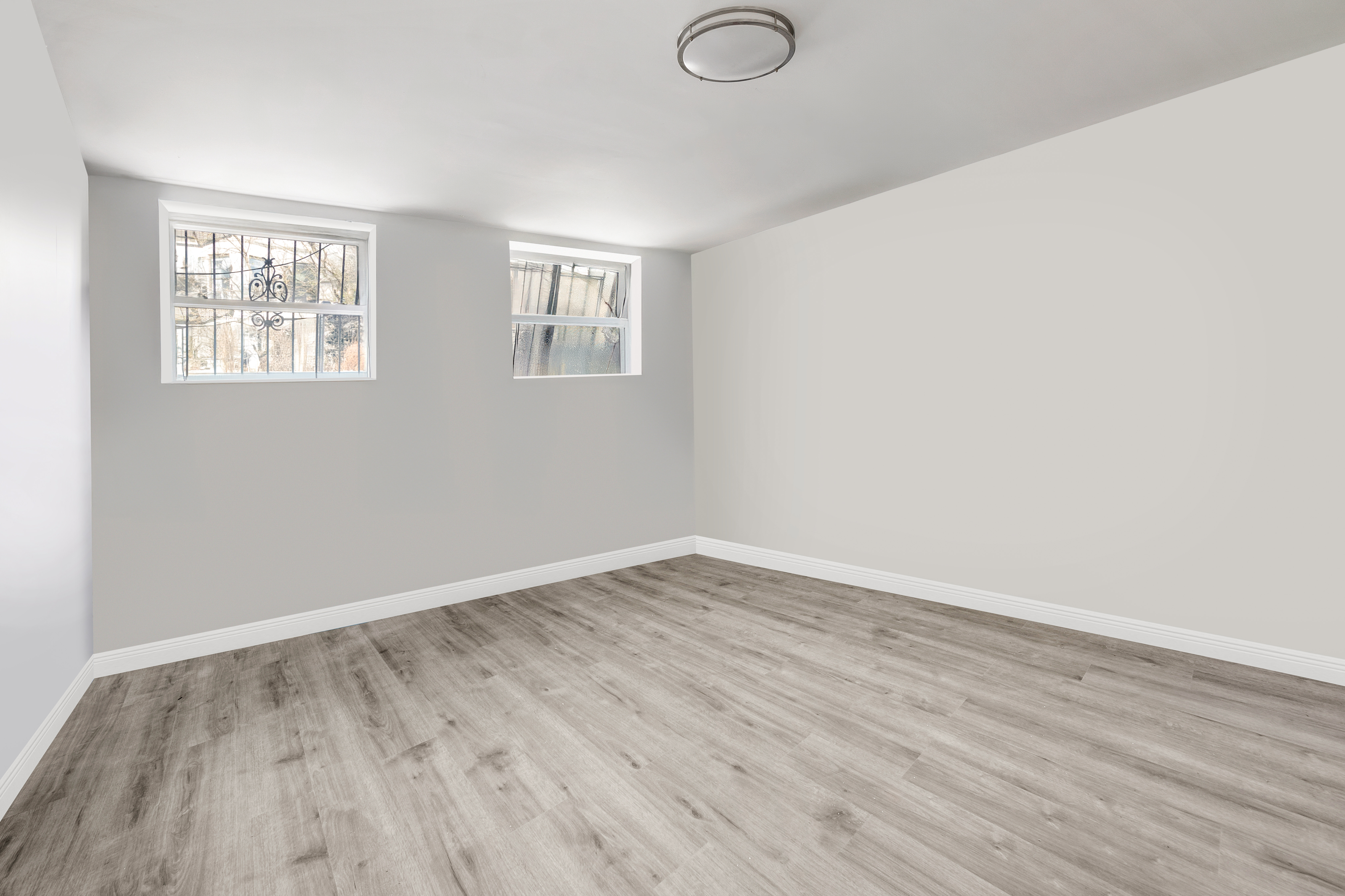 364 Chauncey Street Brooklyn, NY 11233 - Photo 4 of 17 an empty room with wooden floor and windows