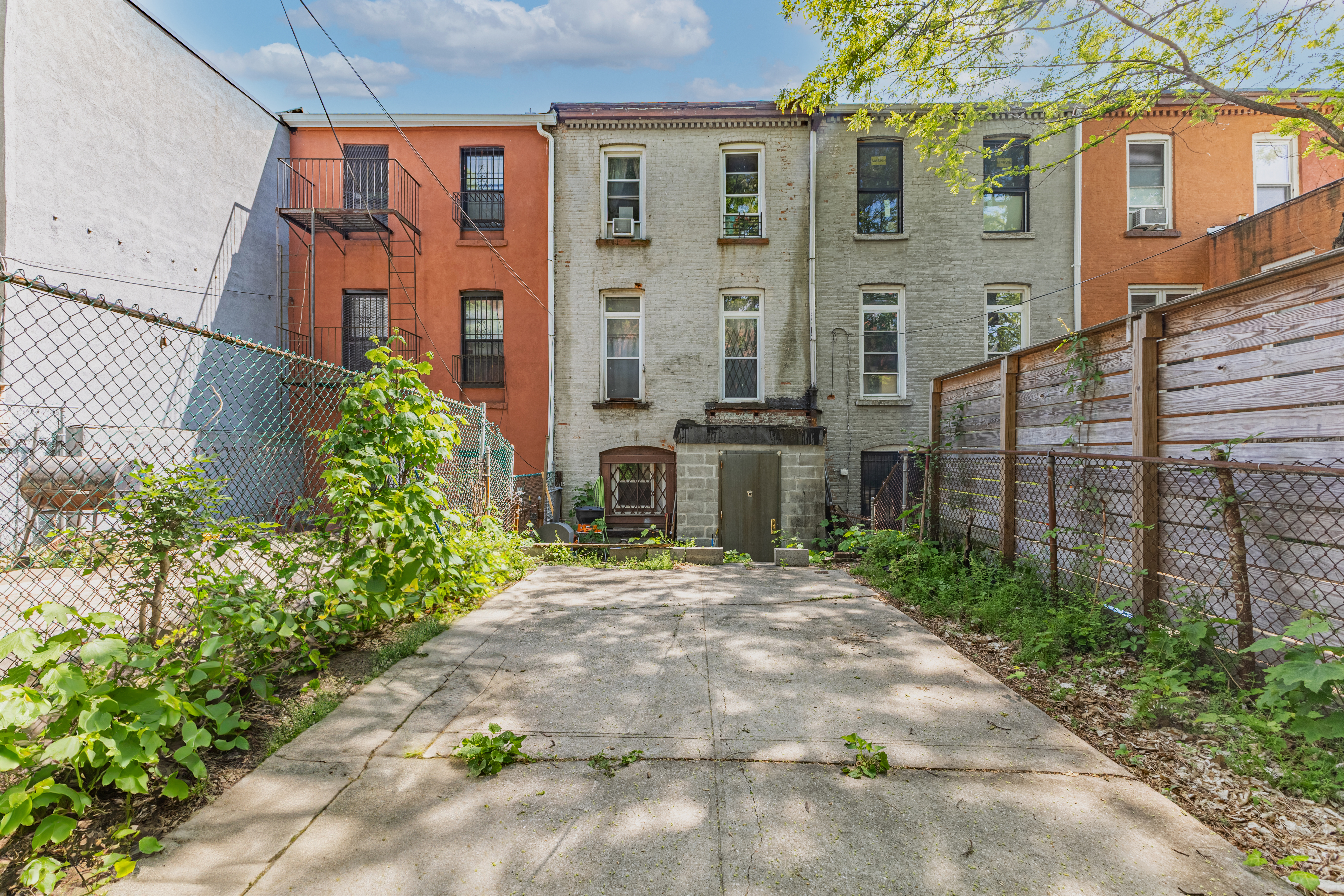 799 Willoughby Avenue Brooklyn, NY 11206 - Photo 6 of 12 a view of a brick building next to a yard
