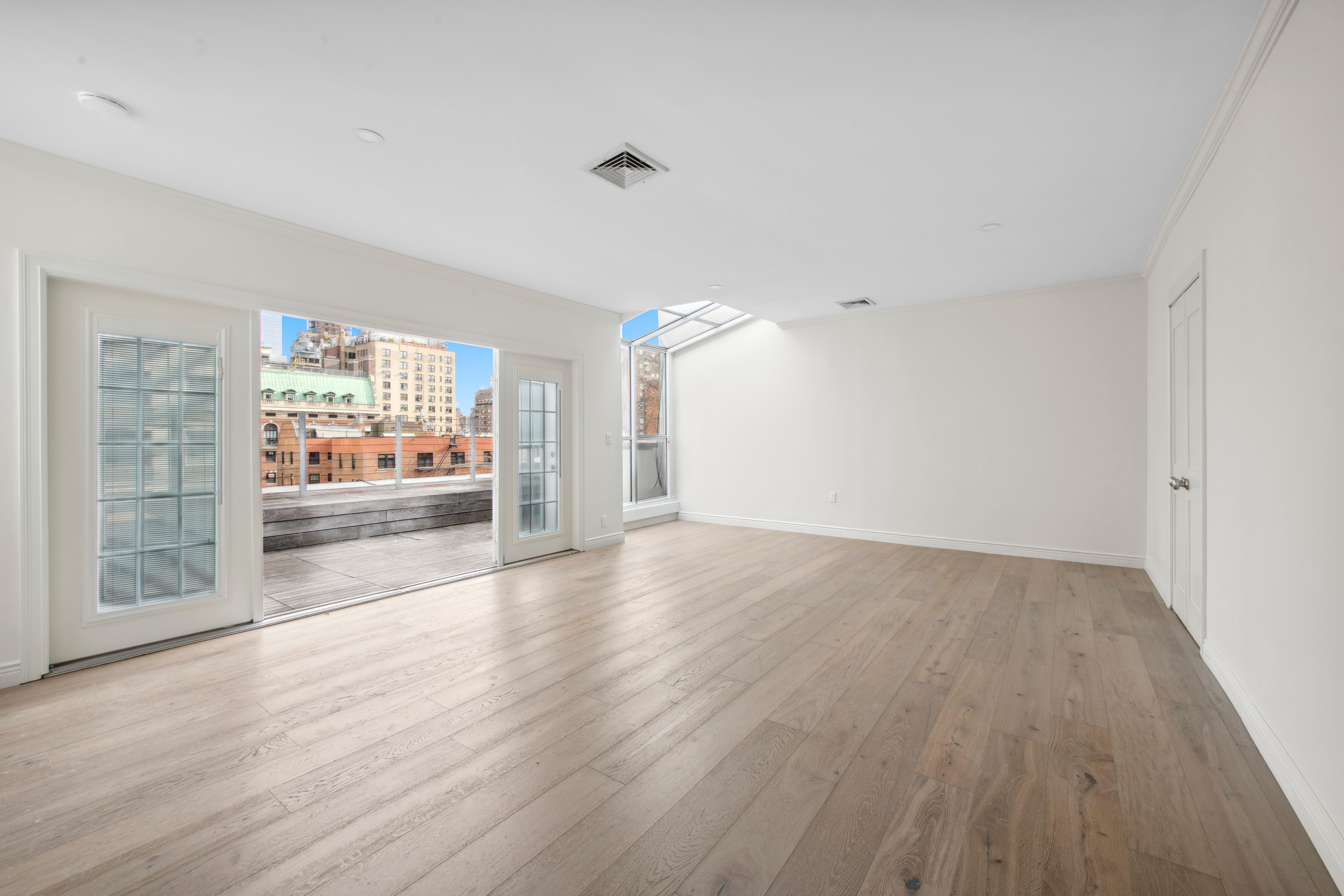 212 East 70th Street, Unit 4B Manhattan, NY 10021 - Photo 8 of 16 wooden floor in an empty room with a window